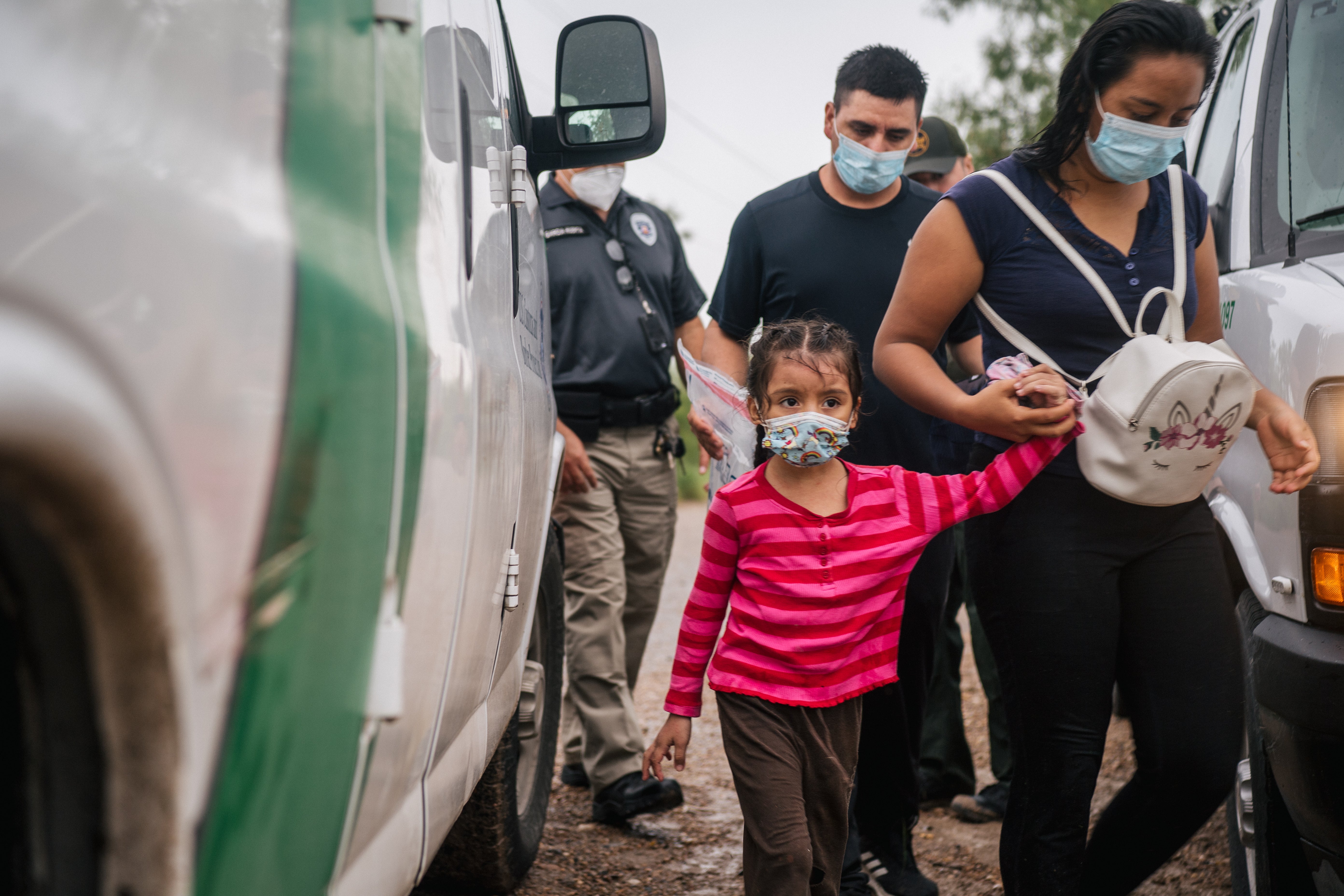 An immigrant family seeking asylum prepare to be taken to a border patrol processing facility after crossing into the US on 16 June, 2021 in La Joya, Texas. US Attorney General Merrick Garland has reversed two Trump-era asylum decisions.