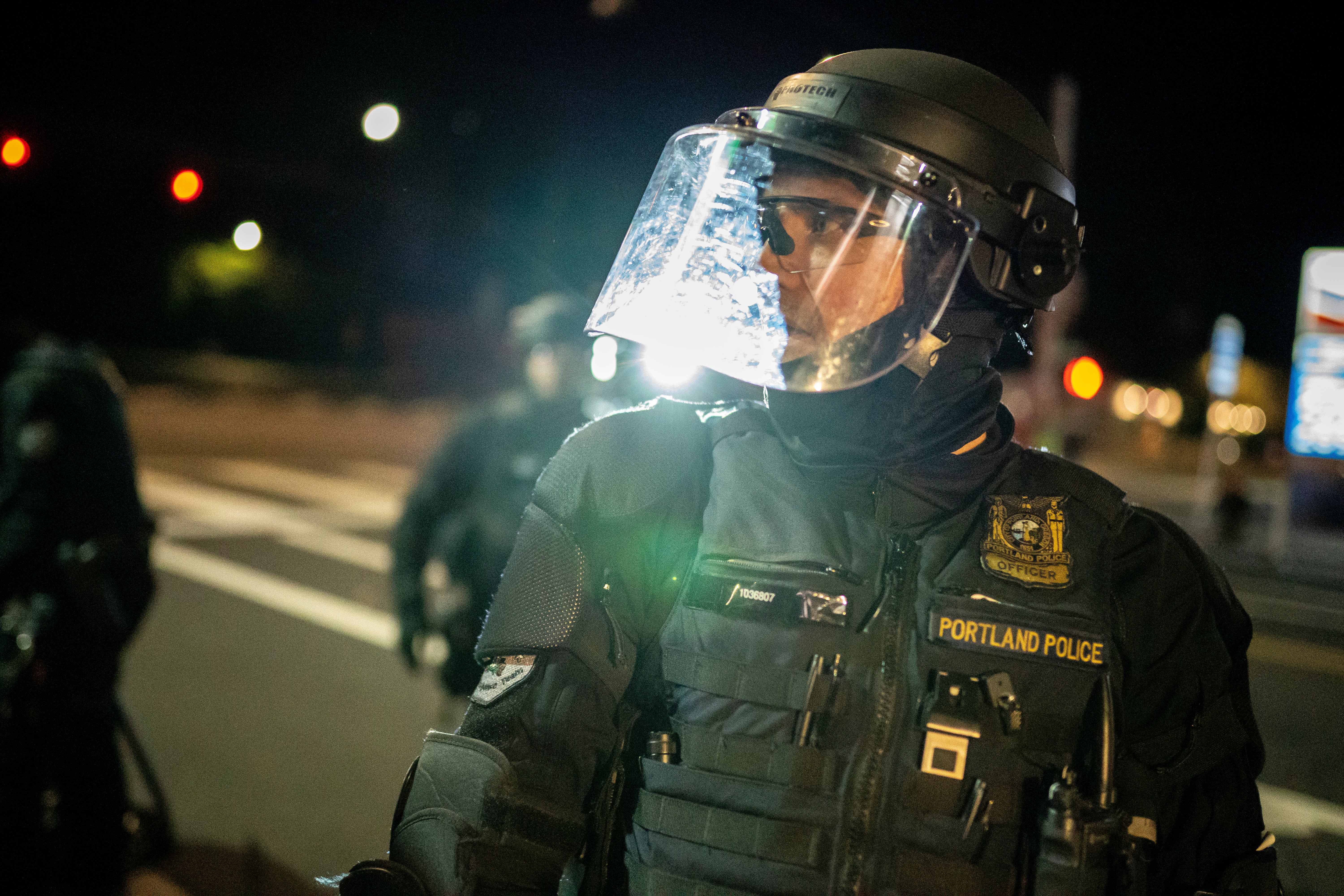 Portland police disperse a crowd after protesters set fire to the Portland Police Association (PPA) building early in the morning on 29 August, 2020 in Portland, Oregon.