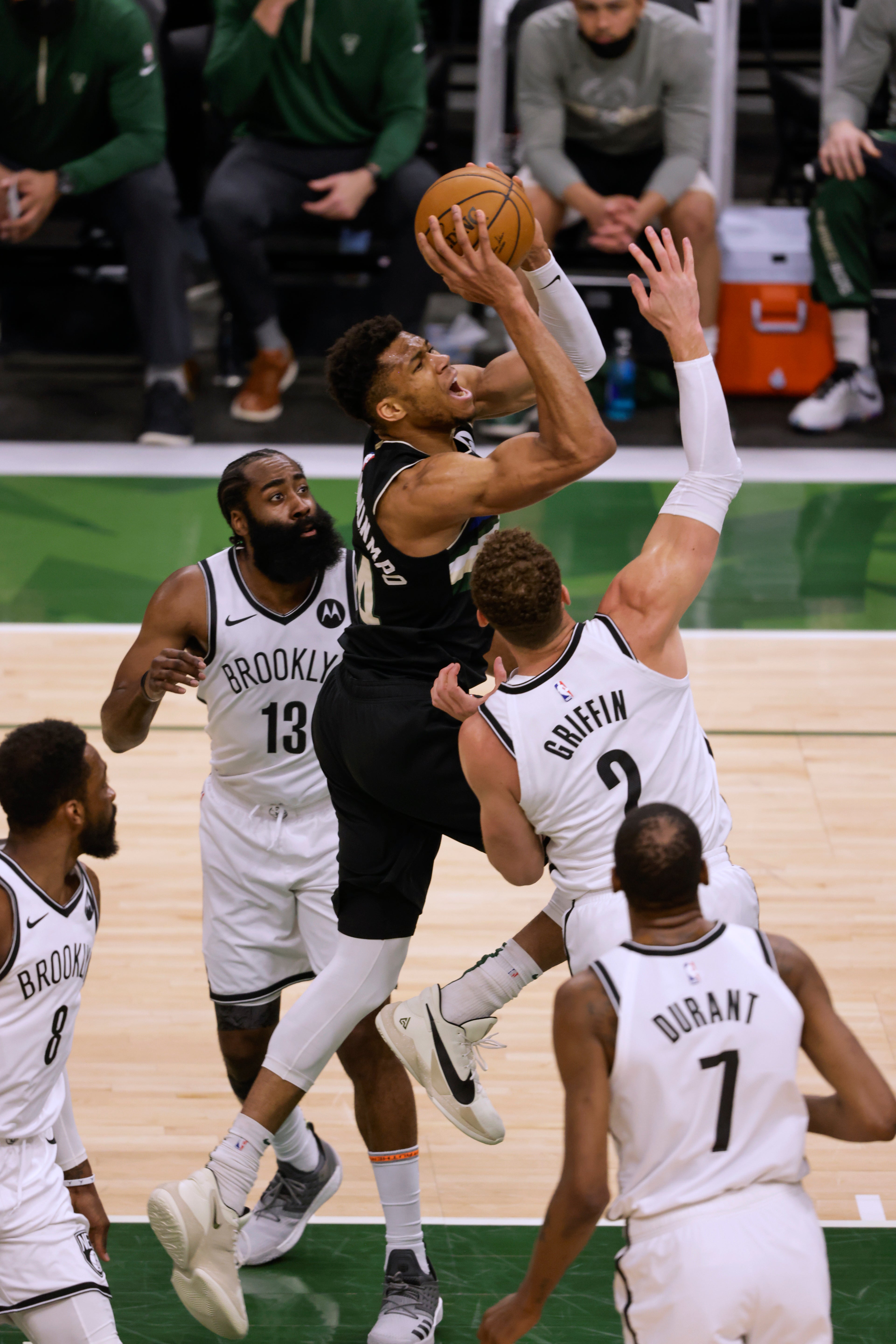 Milwaukee Bucks forward Giannis Antetokounmpo drives between Brooklyn Nets’ James Harden and Blake Griffin