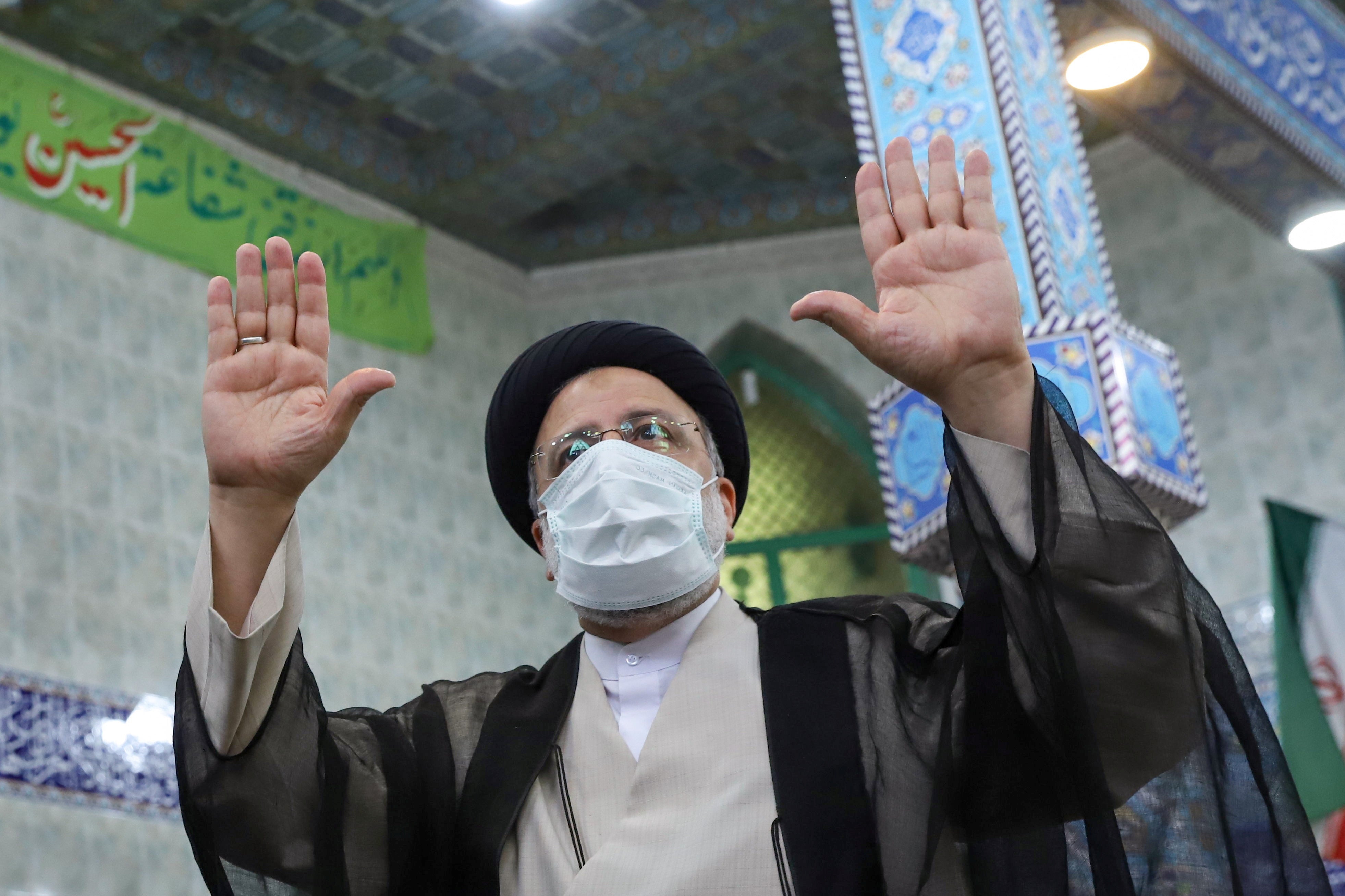 Presidential candidate Ebrahim Raisi gestures after casting his vote