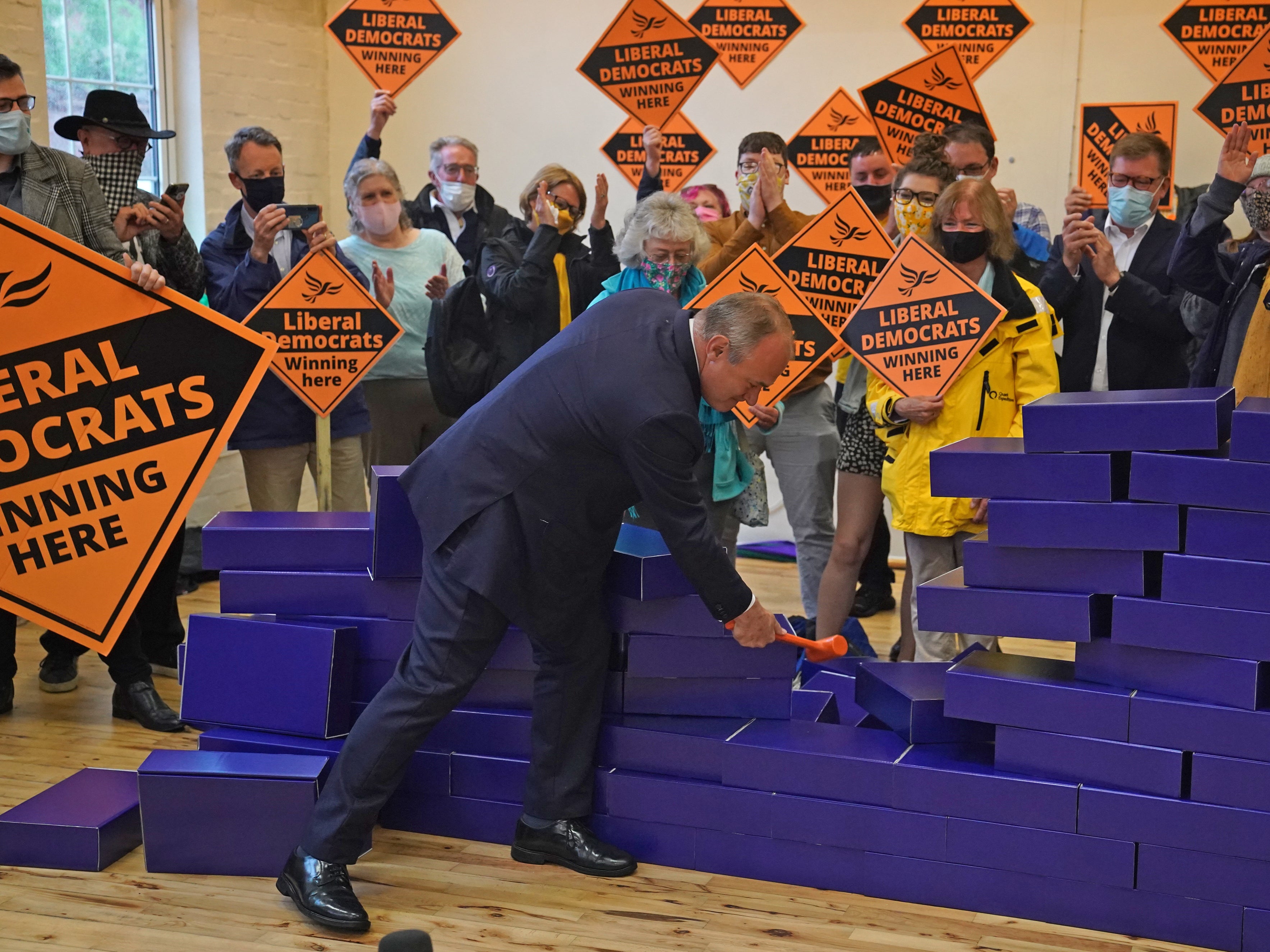 Sir Ed Davey smashing symbolic blue wall after by-election win