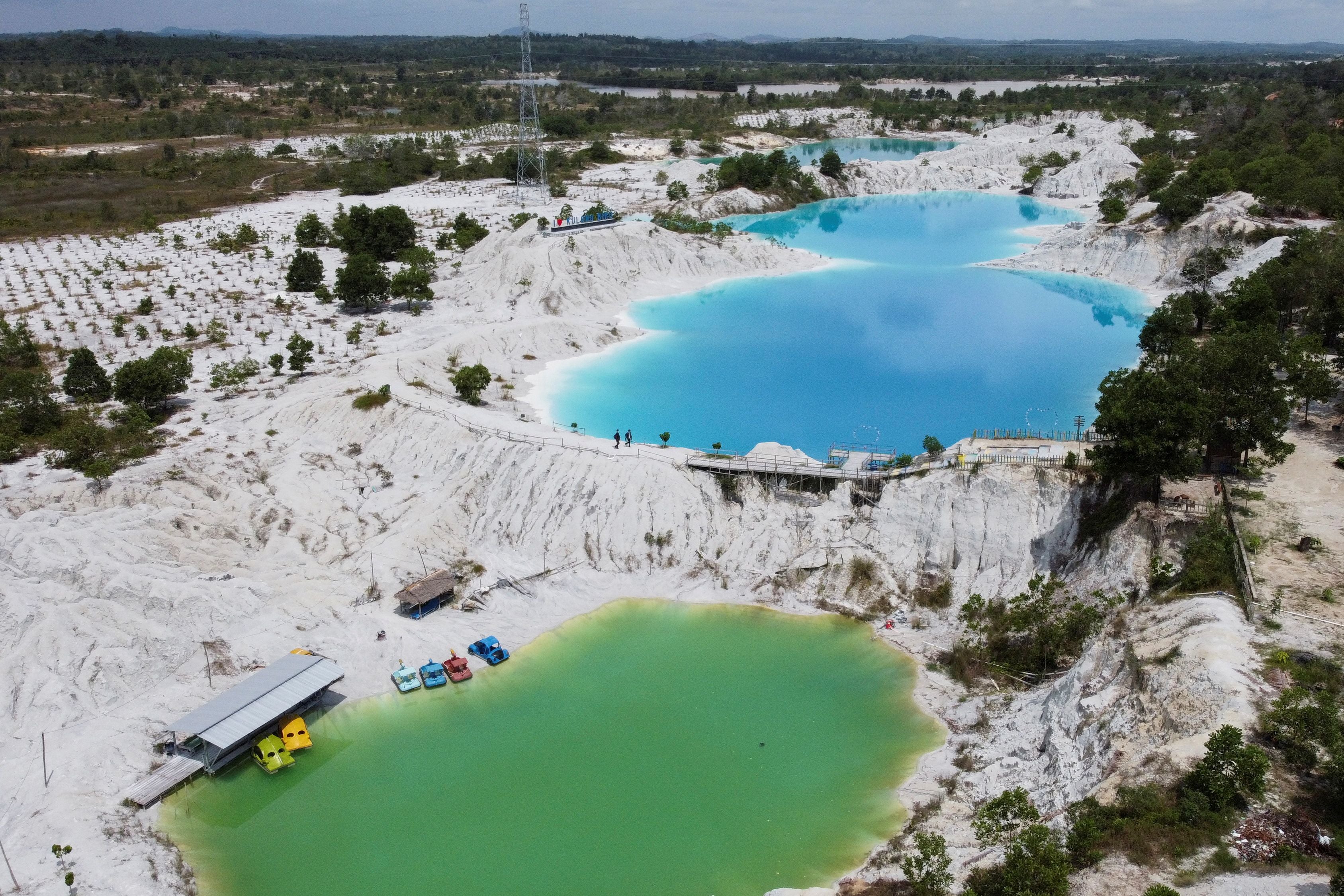 An aerial view shows a lake known as Kulong Biru (blue lake) in Koba, on the island of Bangka, Indonesia. Deposits in the mining hub of Bangka-Belitung have been heavily exploited on land, leaving parts of the islands off the southeast coast of Sumatra Island resembling a lunar landscape with vast craters and highly acidic, turquoise lakes