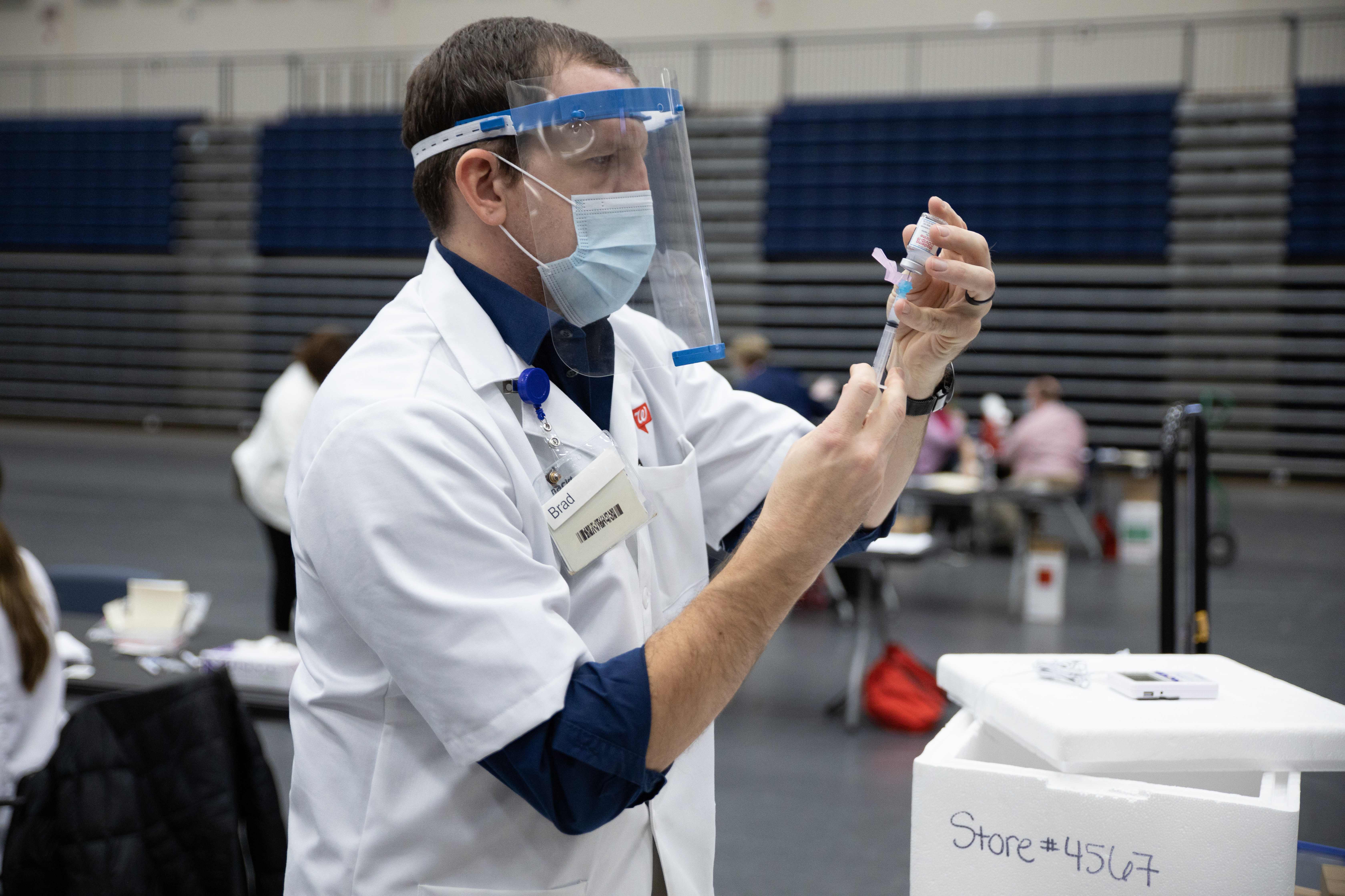 Walgreens staff prepare vaccines for educational staff at Kettering City Schools to receive the Covid-19 vaccine as a part of Ohio’s Phase 1B vaccine distribution in Dayton, Ohio on 10 February 2021
