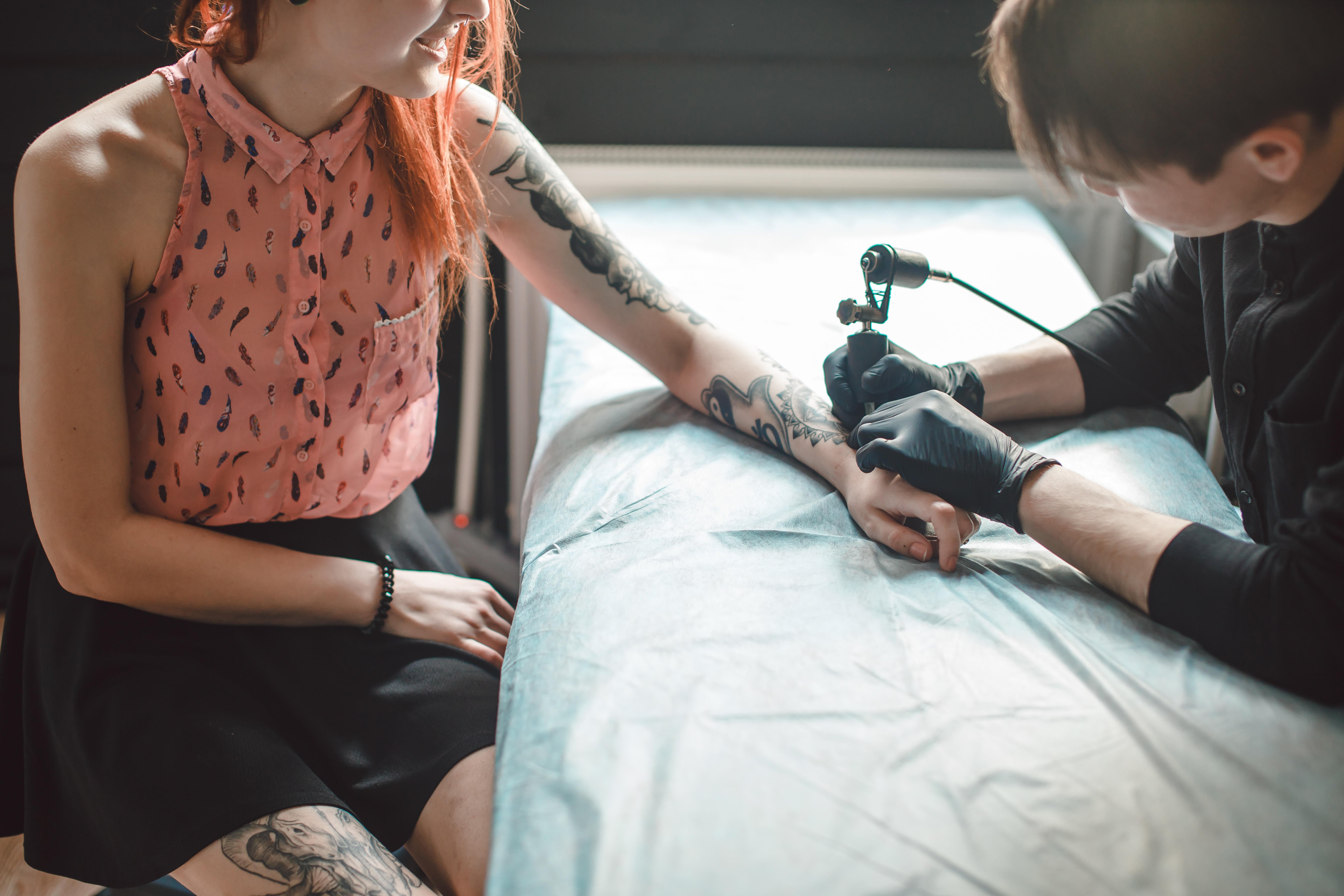 woman getting tattoo