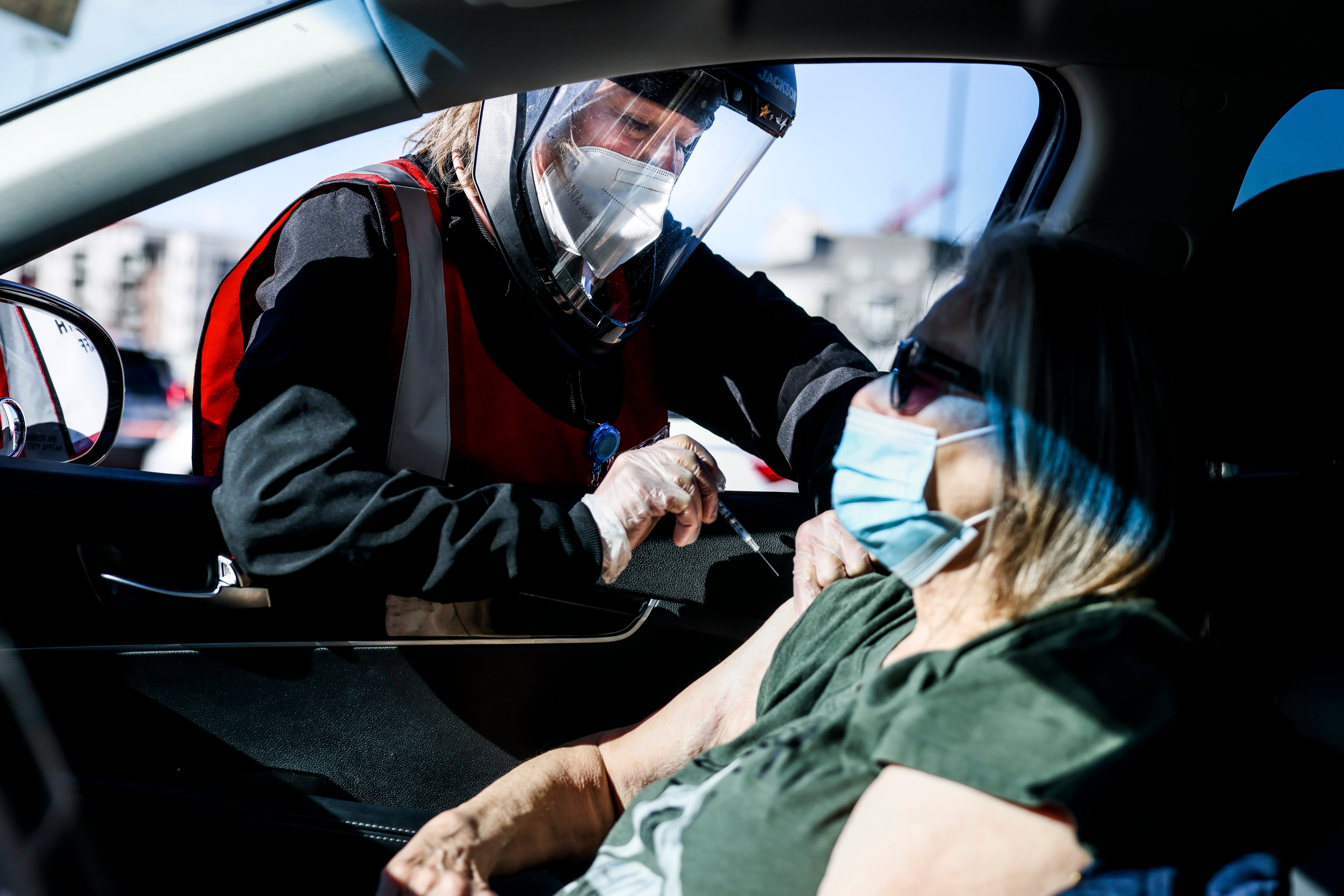 Health registered nurse Karen Nerger administers a dose of the Pfizer-BioNTech vaccine at a mass COVID-19 vaccination event on 30 January, 2021 in Denver, Colorado. Half of unvaccinated adults definitely do not want to get the jab, a new poll has found.