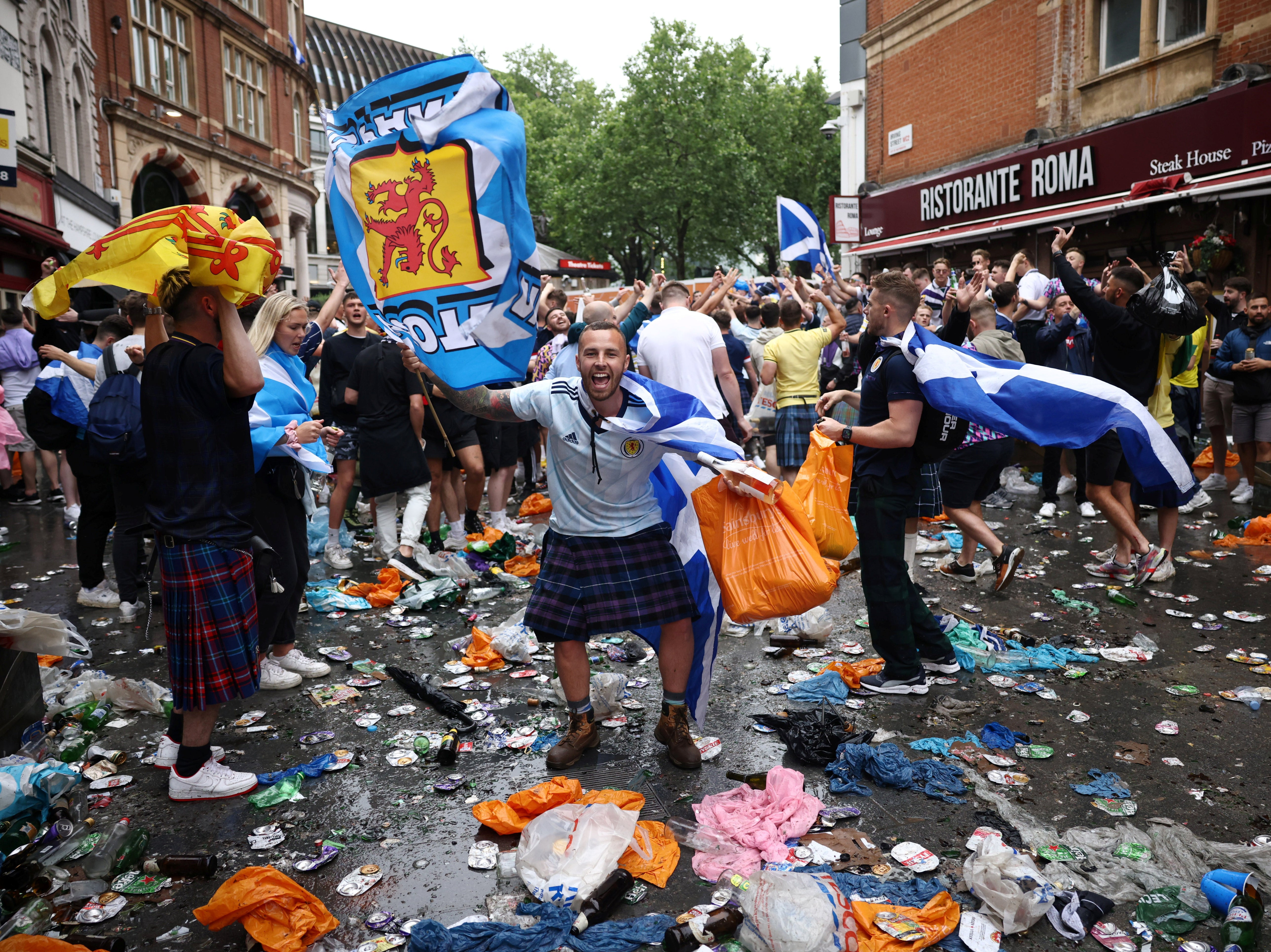 Plastic bags and drinks containers cover the ground near Leicester Square