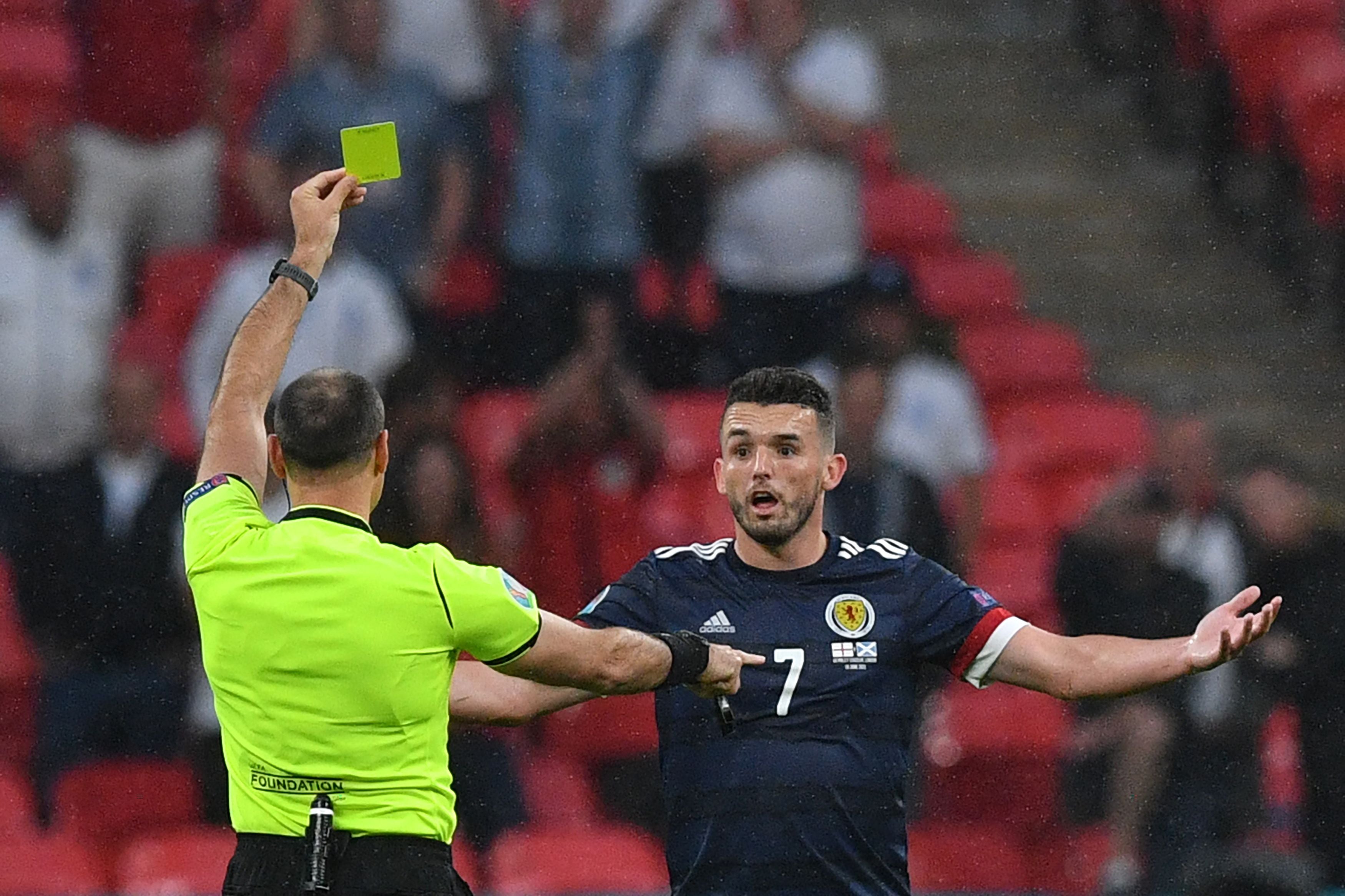 John McGinn is shown a yellow card