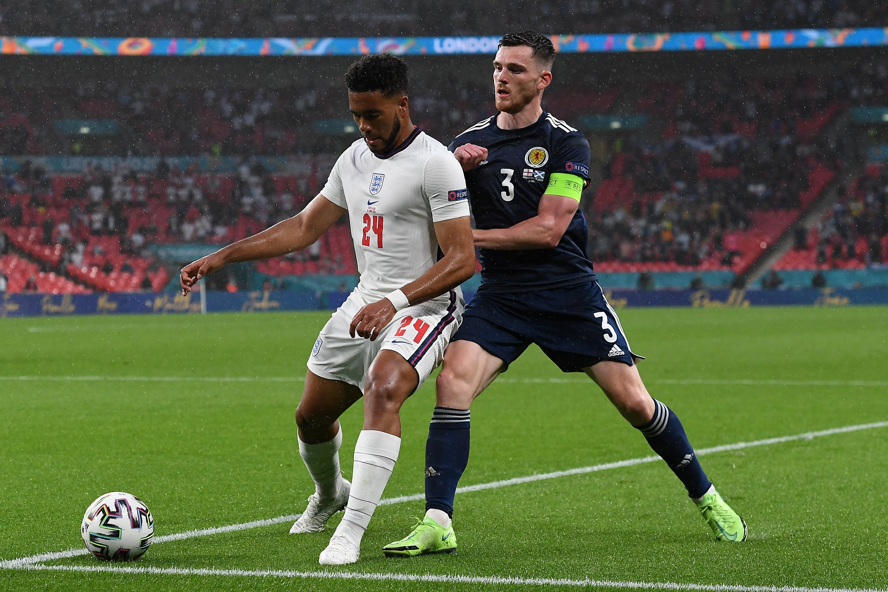 Reece James shields the ball from Andy Robertson