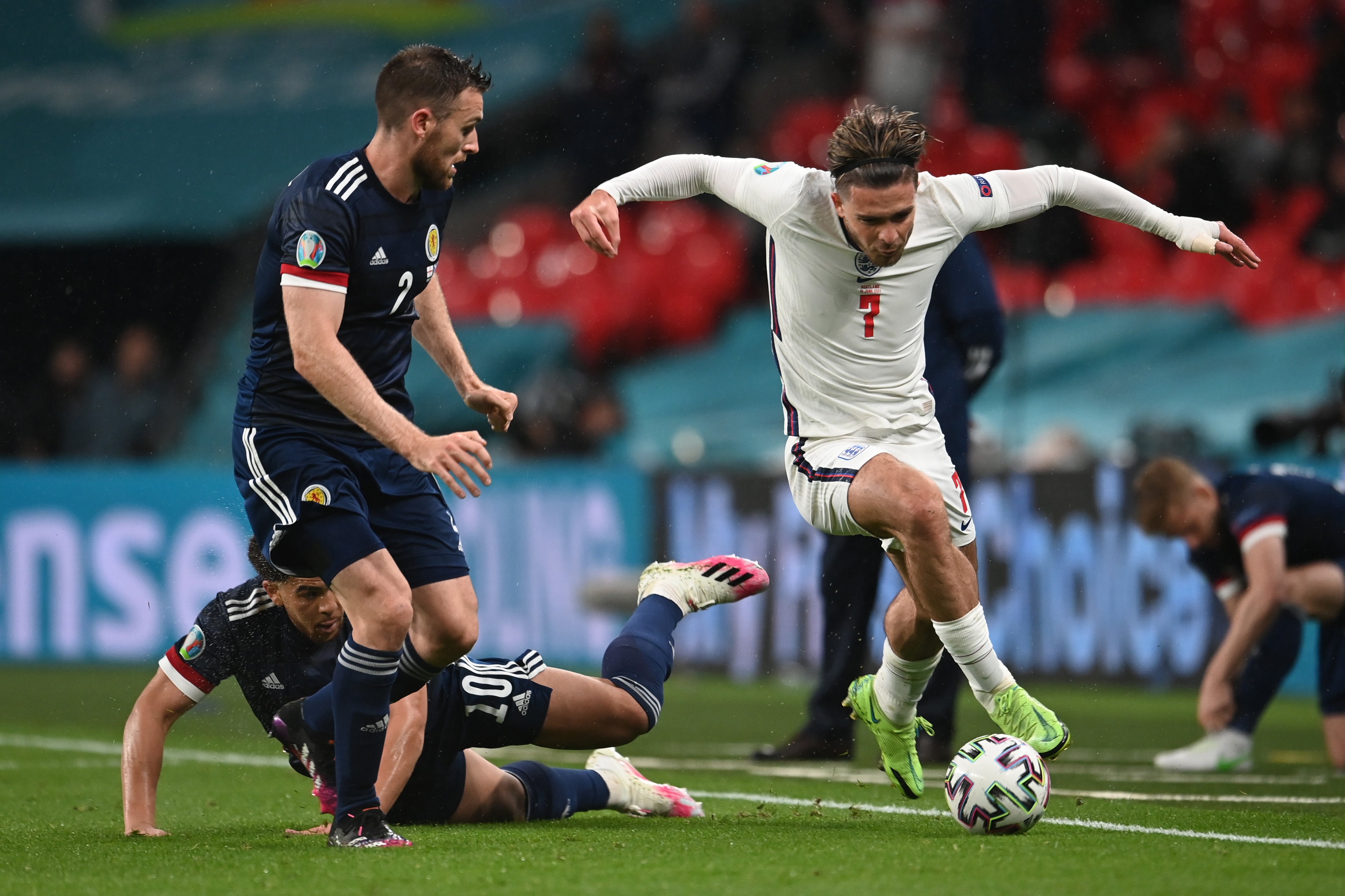 Jack Grealish runs with the ball whilst under pressure from Stephen O'Donnell and Che Adams