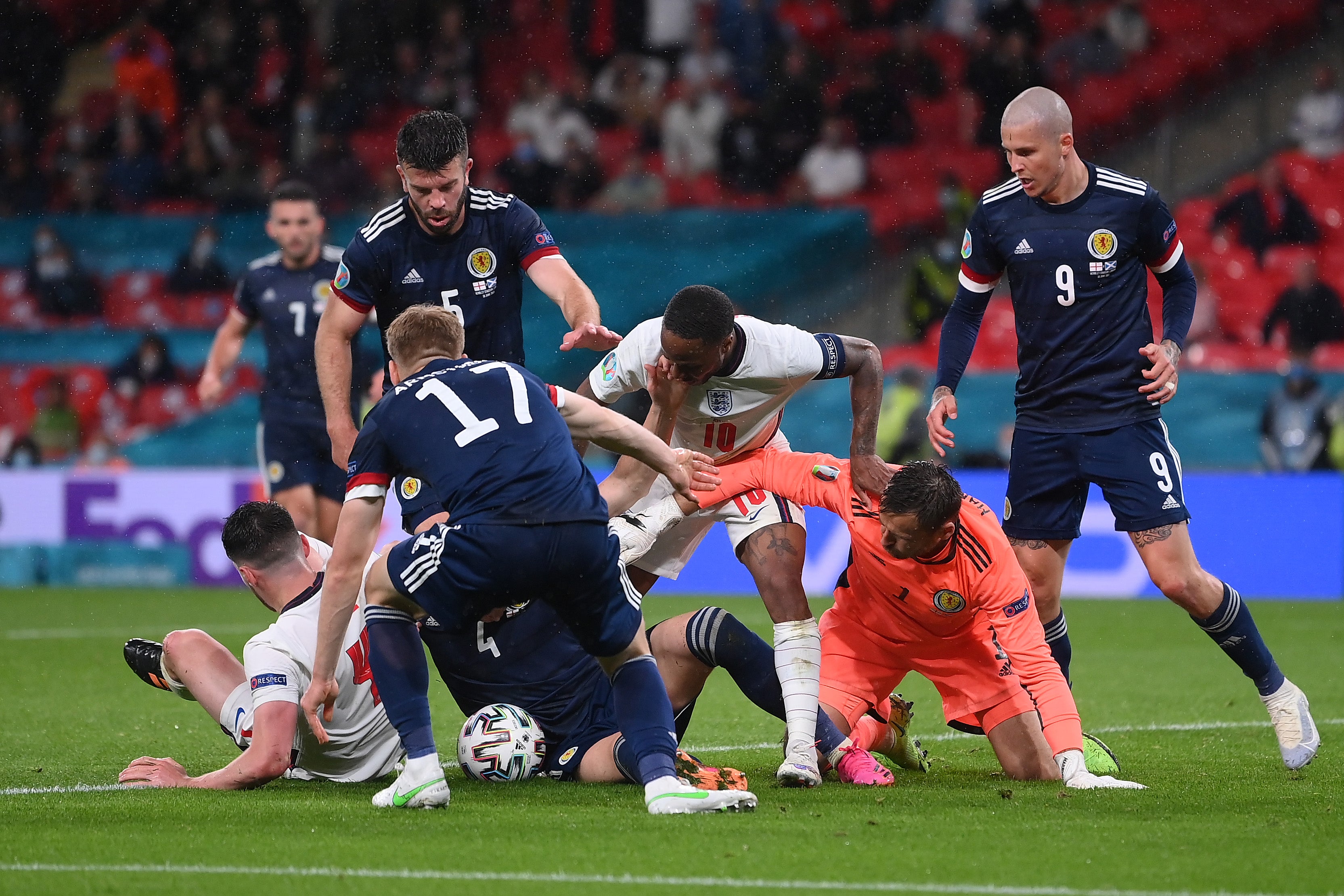 Raheem Sterling battles for possession with David Marshall