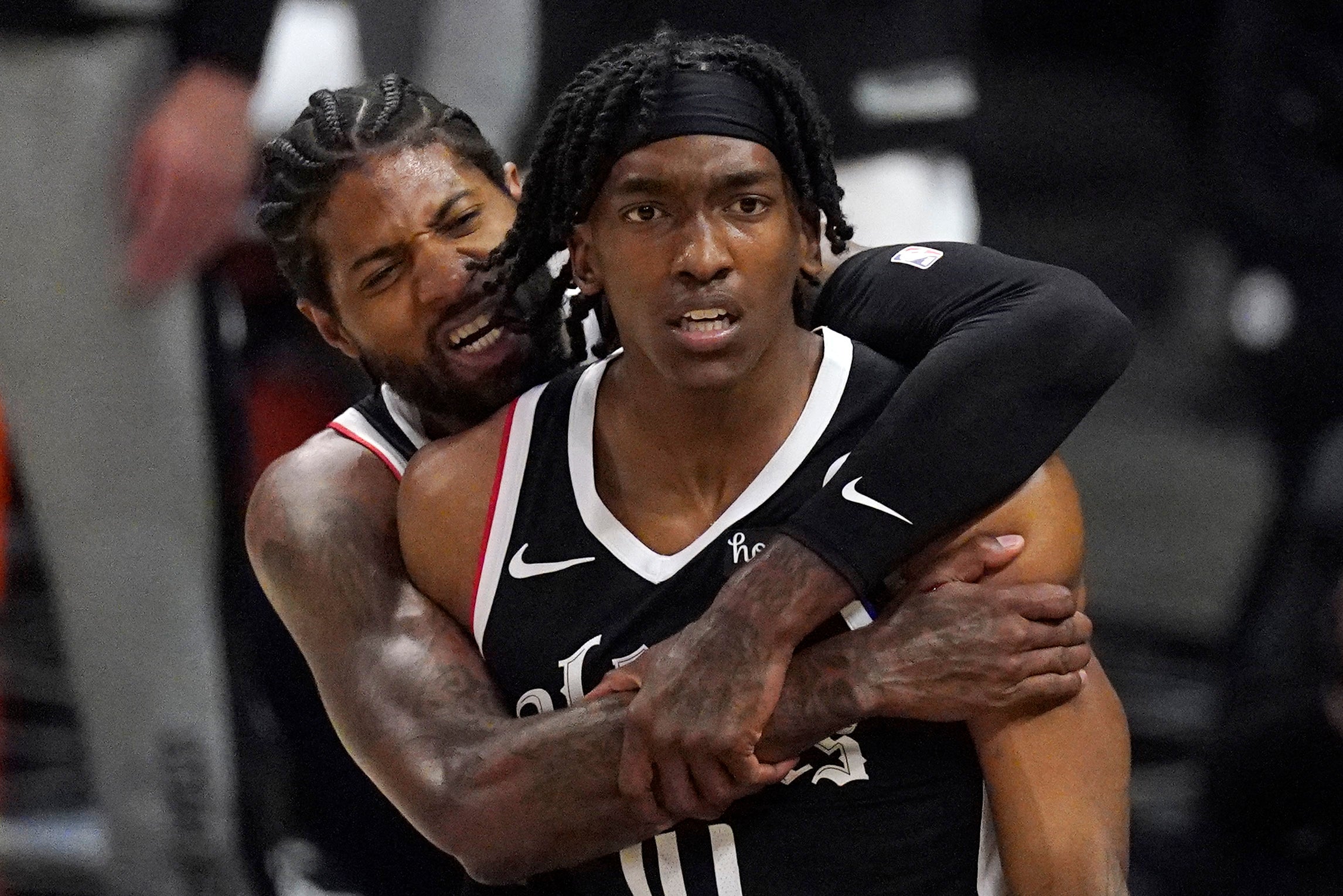 Los Angeles Clippers guard Terance Mann, right, celebrates with guard Paul George