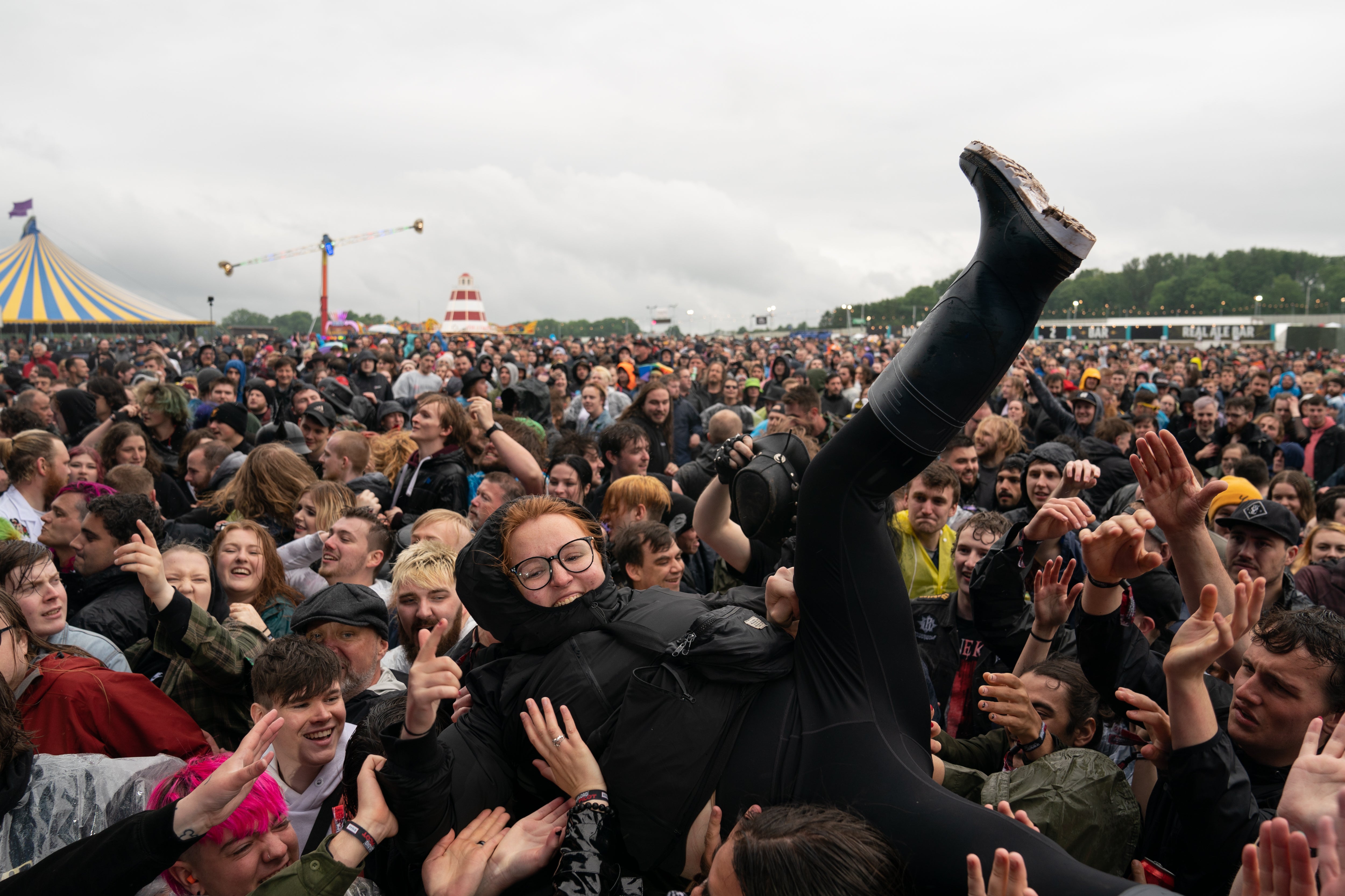 A festivalgoer crowd surfs on the first day of Download Festival at Donington Park in Leicestershire