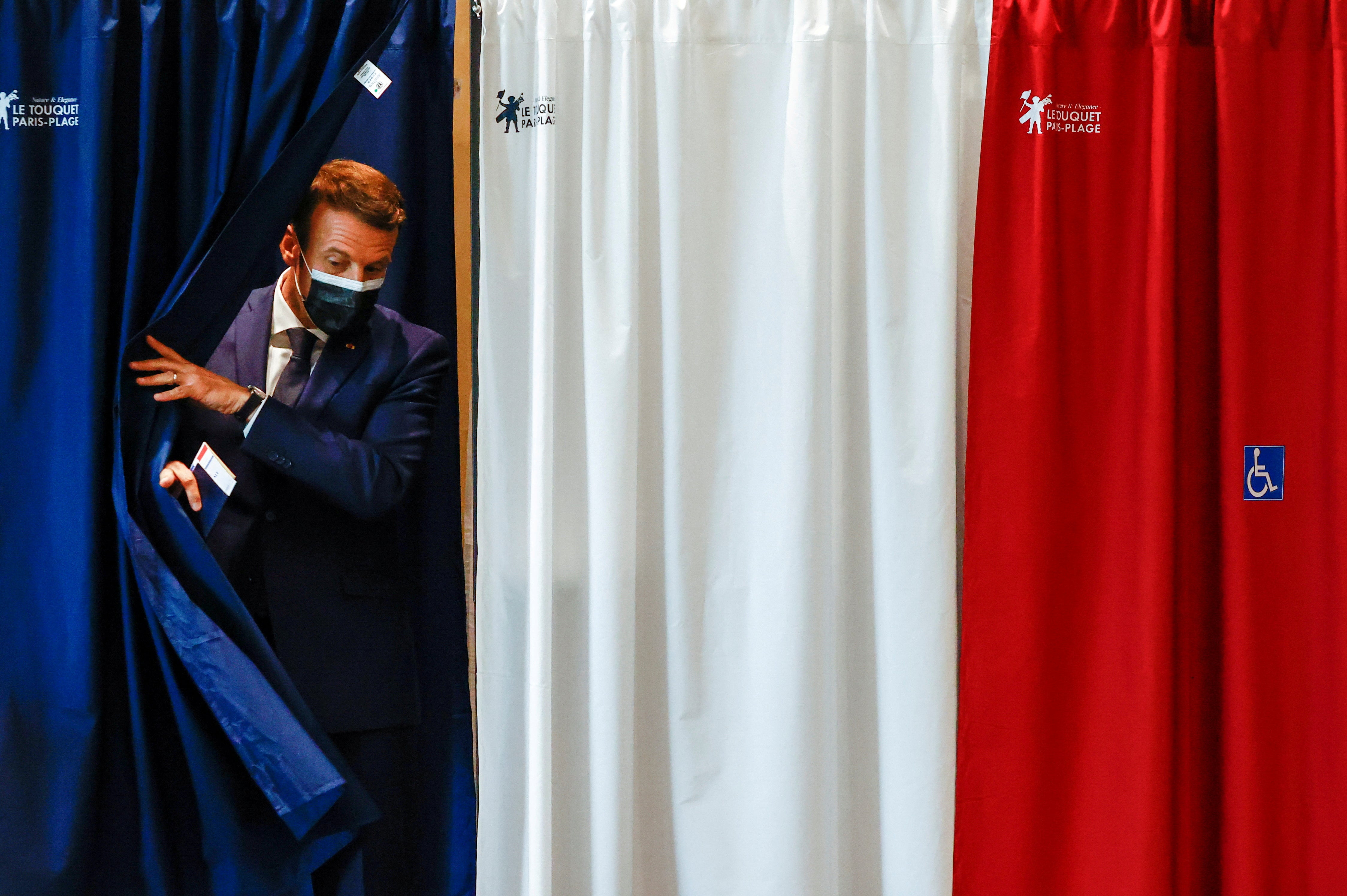 French president Emmanuel Macron is seen at a polling station during the first round of French regional and departmental elections