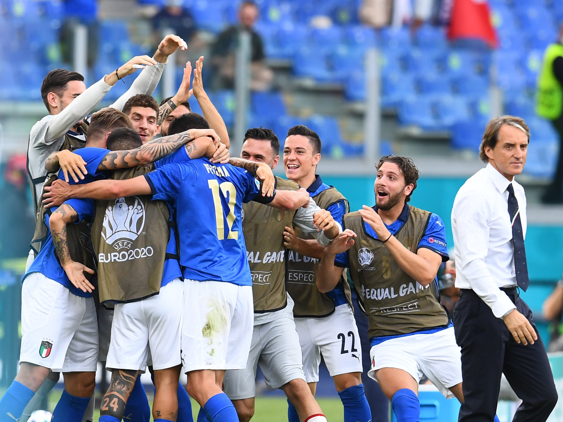 Roberto Mancini looks on as Matteo Pessina celebrates after scoring