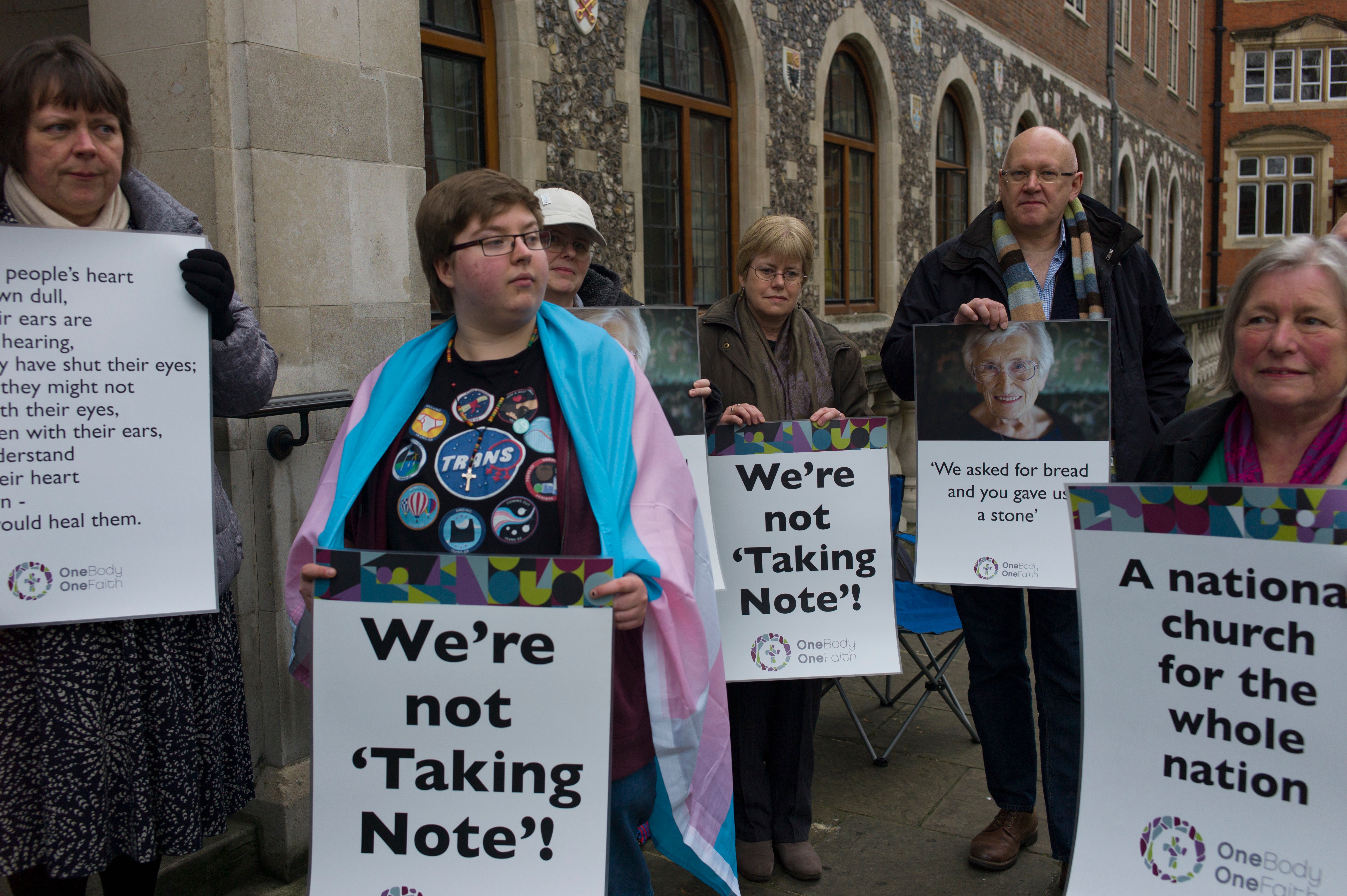 Members of the LGBT+ community stage a peaceful protest outside Church House in London, England