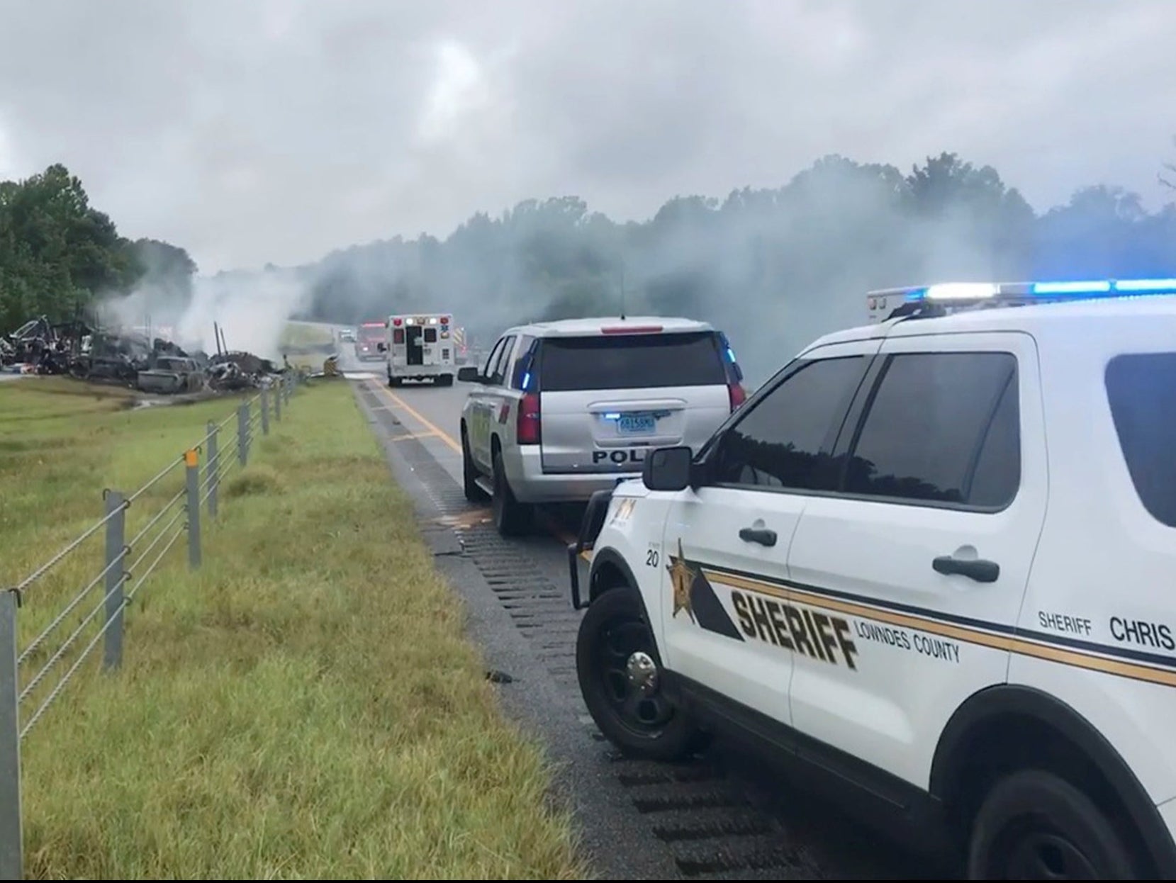 Smoke rises from the wreckage of a collision in Alabama