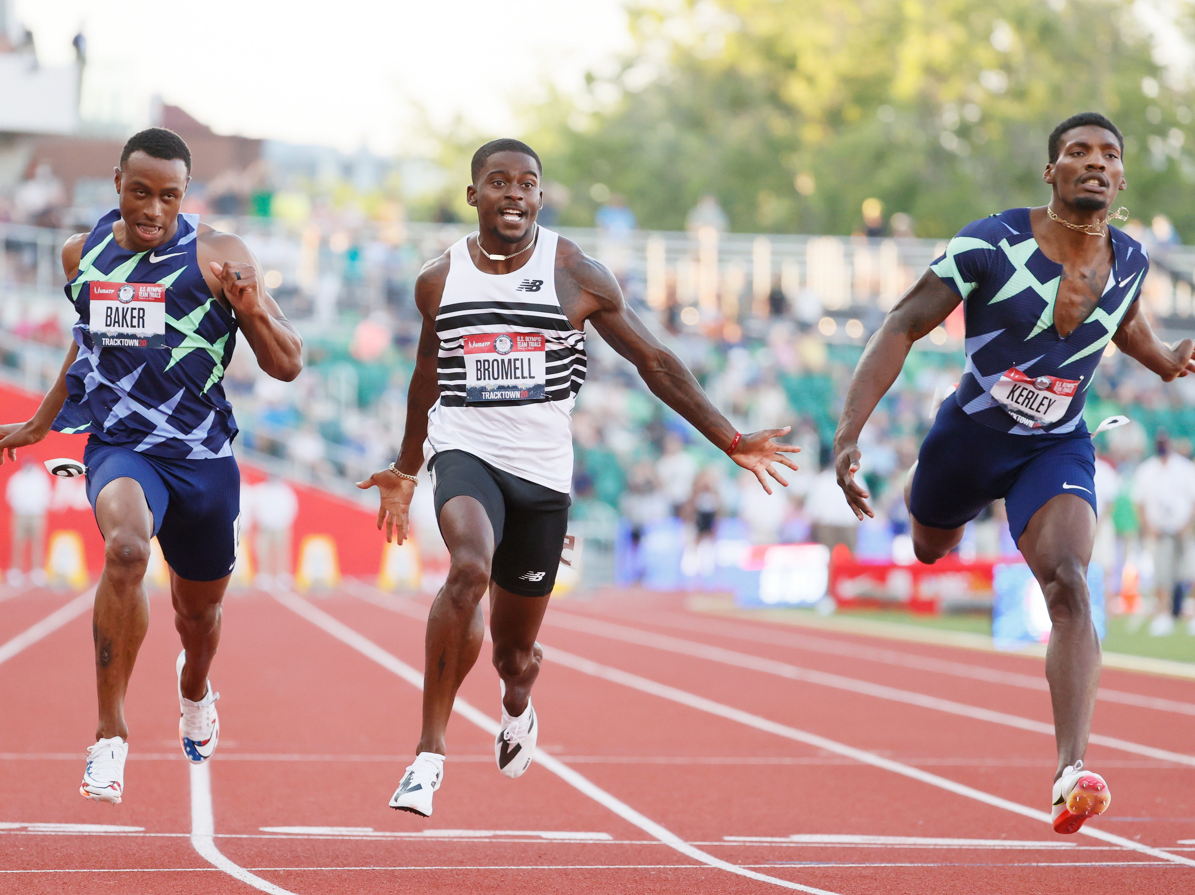 Trayvon Bromell, Ronnie Baker and Fred Kerley cross the finish line to secure a place at the Tokyo Olympics