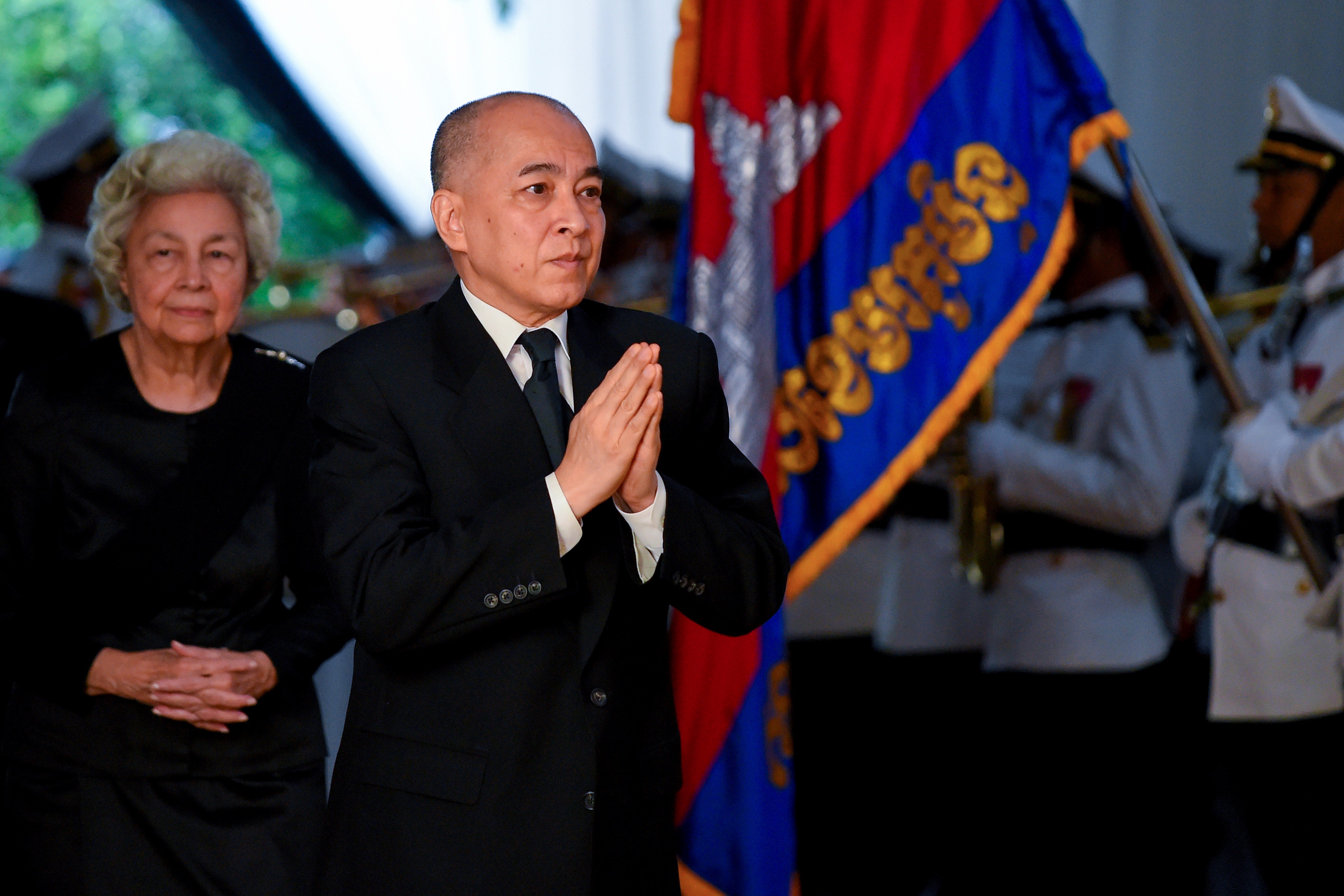 Cambodia’s King Norodom Sihamoni (C) and his mother former queen Monique (L)