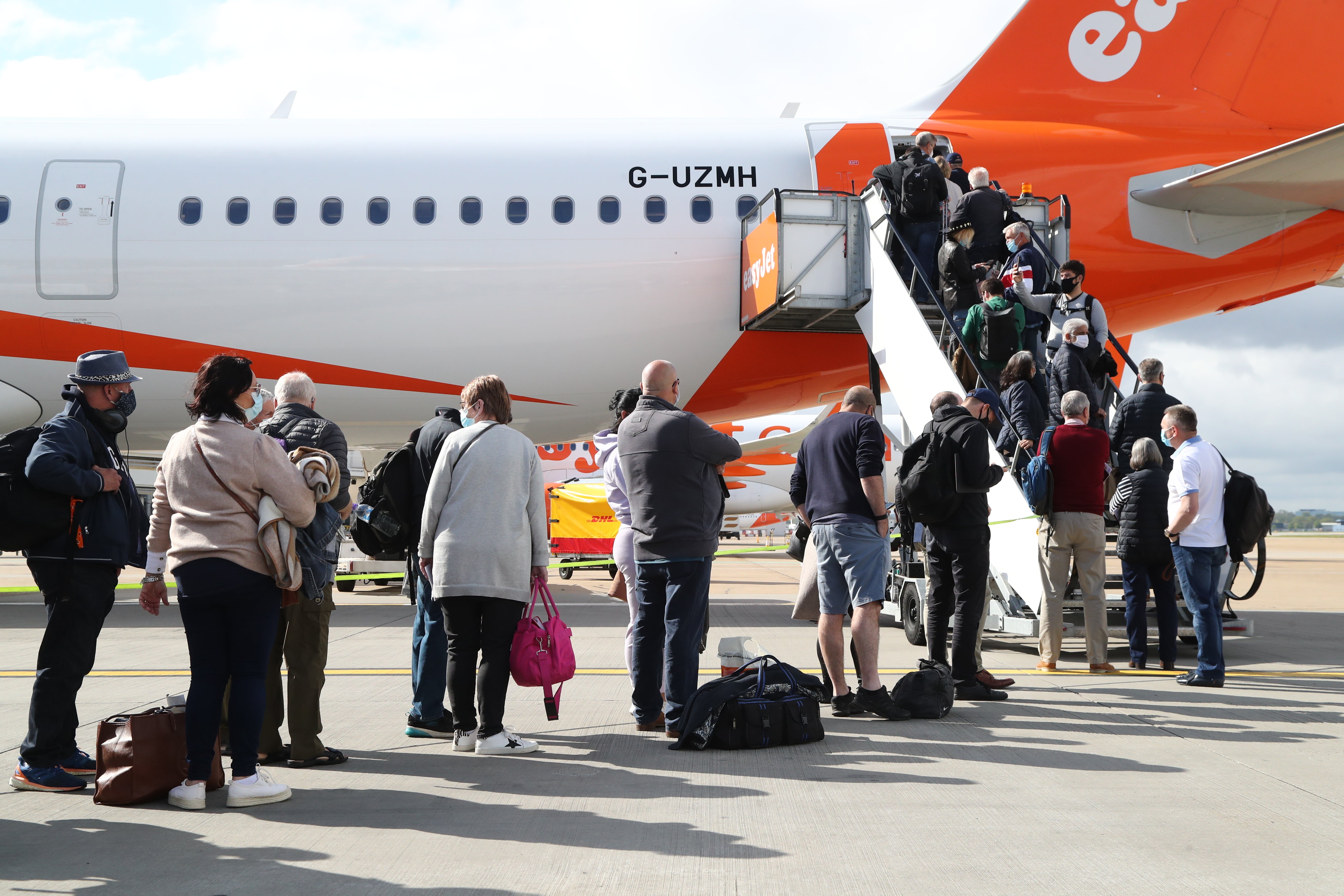 Passengers board an easyJet plane