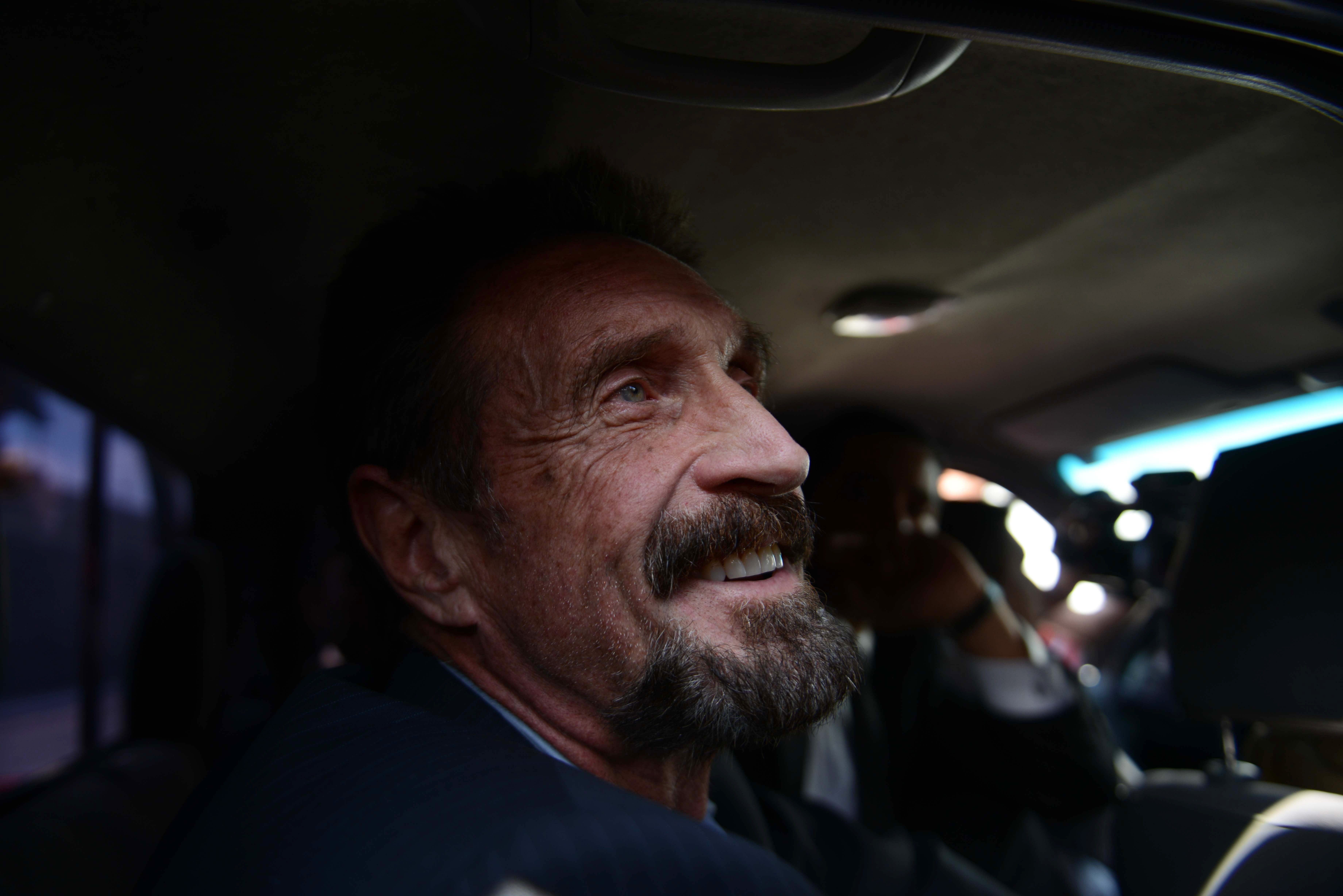 US anti-virus software pioneer John McAfee smiles as he arrives at the Aurora international airport in Guatemala City on December 12, 2012. Mr McAfee was found dead in his prison cell in Spain on Wednesday, 23 June, 2021.