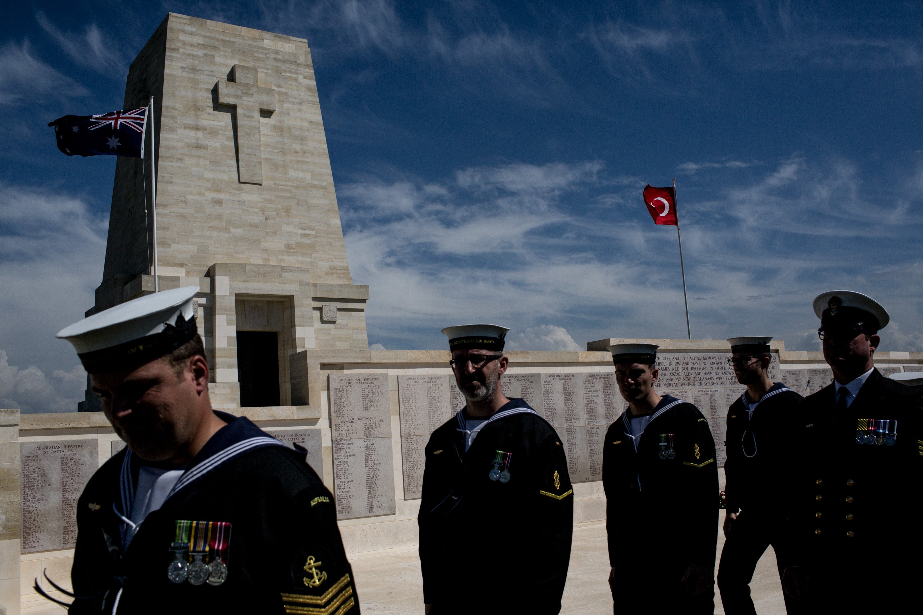 Members of an Australian navy band walk in front of the Galipoli memorial at the Lone Pine Cemetery in Turkey