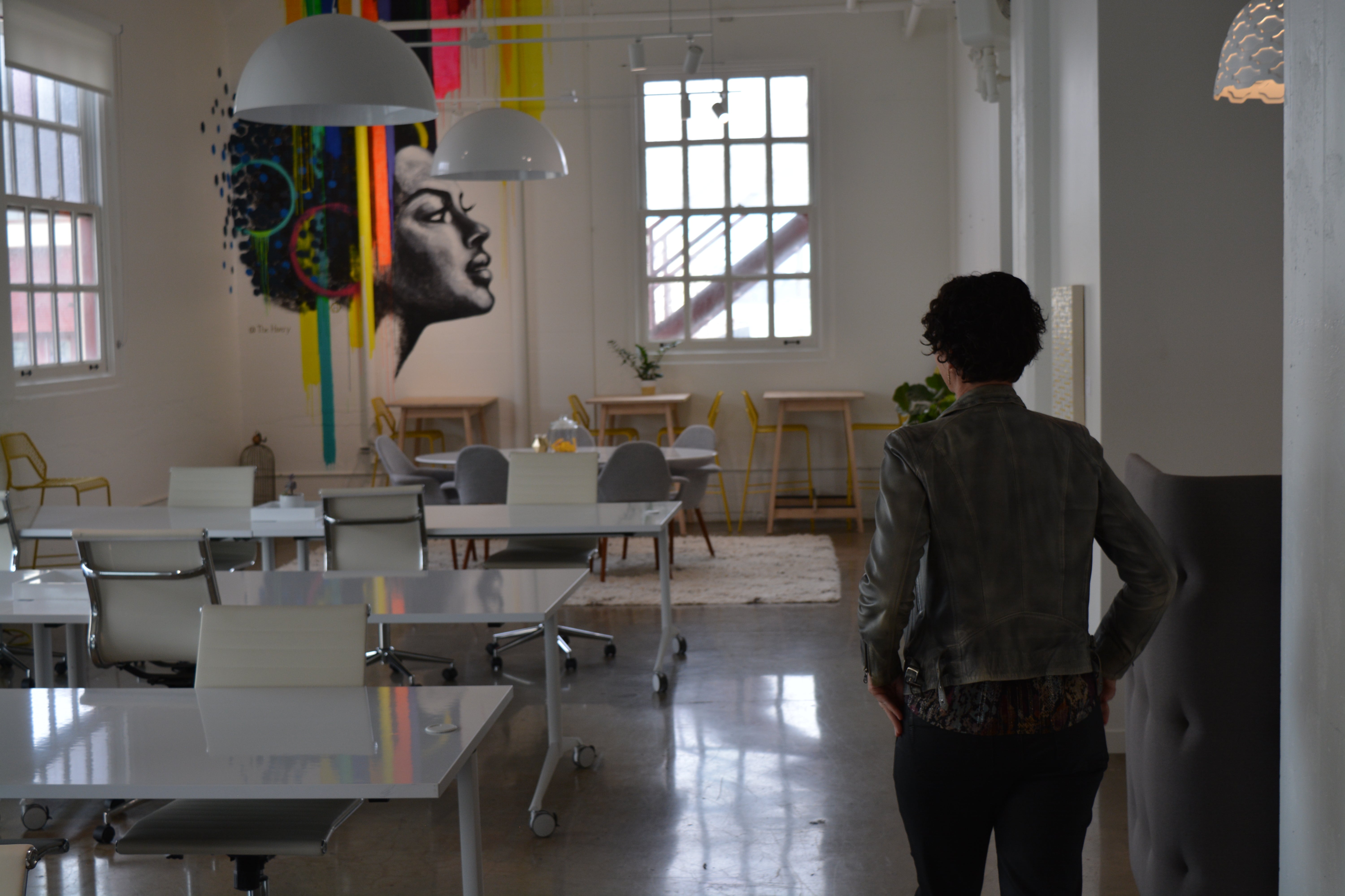 A woman walks through empty offices in a San Francisco coworking space