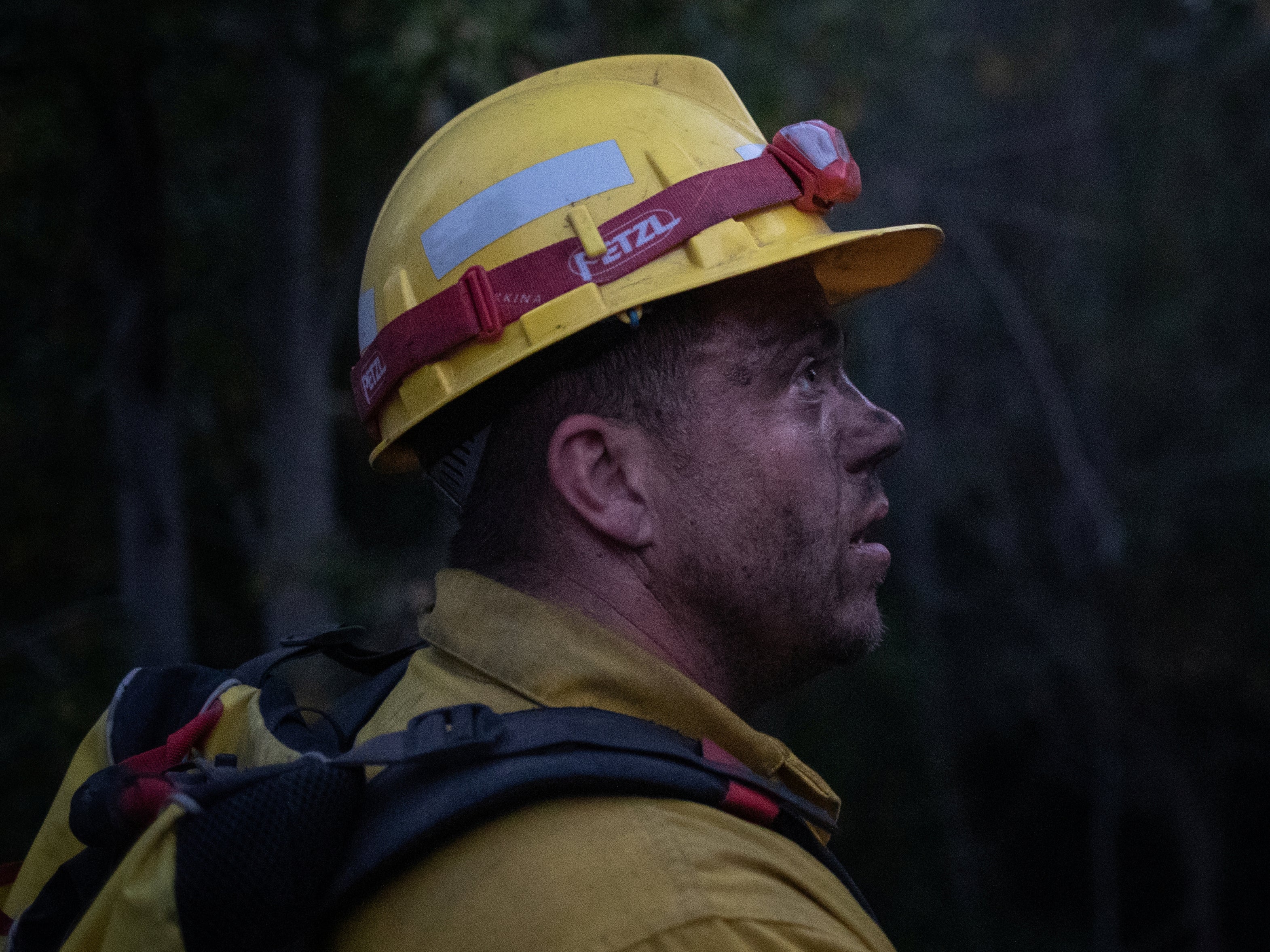 Douglas White, 28, an inmate from Warner Creek Correctional Facility, working as a firefighter, looks on as he is covered in dust and sweat, while helping to mop up hotspots from the Brattain Fire, near Paisley, Oregon, US, 19 September, 2020. REUTERS/Adrees Latif