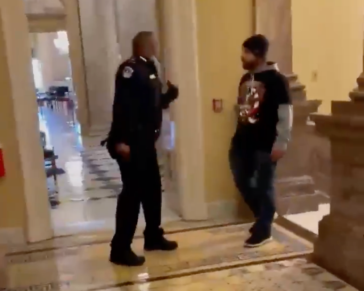 Doug Jensen, right, was caught on video confronting Capitol Police Officer Eugene Goodman during the 6 January attack