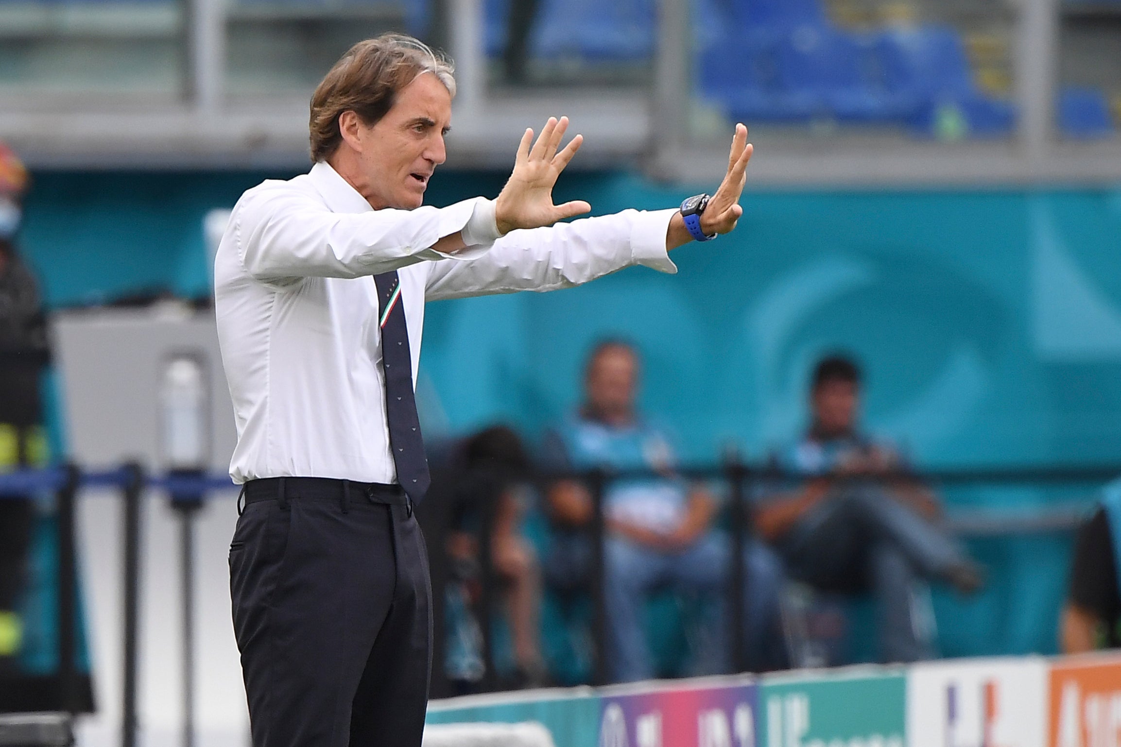 Italy coach Roberto Mancini stands with arms outstretched