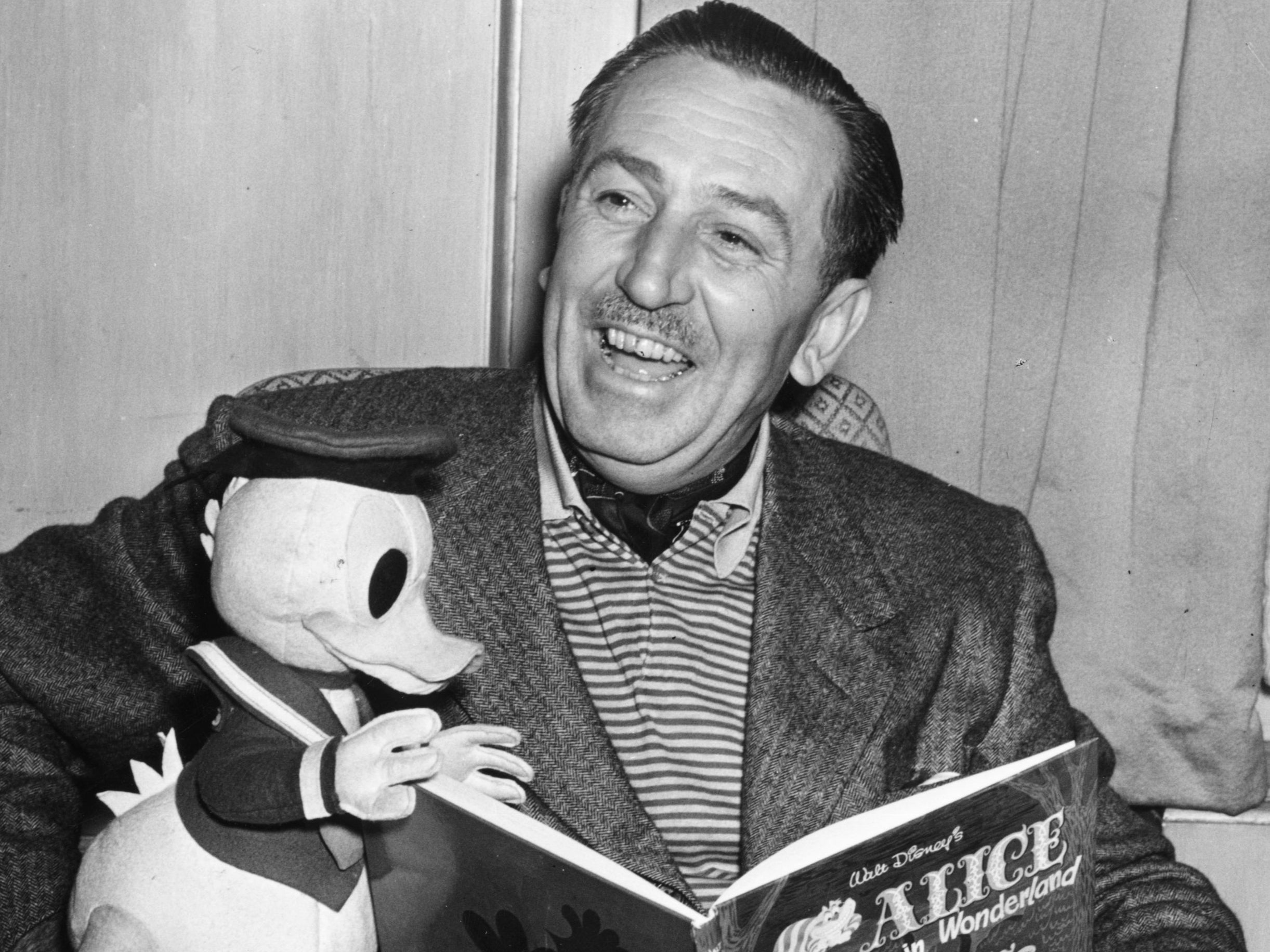 Walt Disney reads to Donald Duck