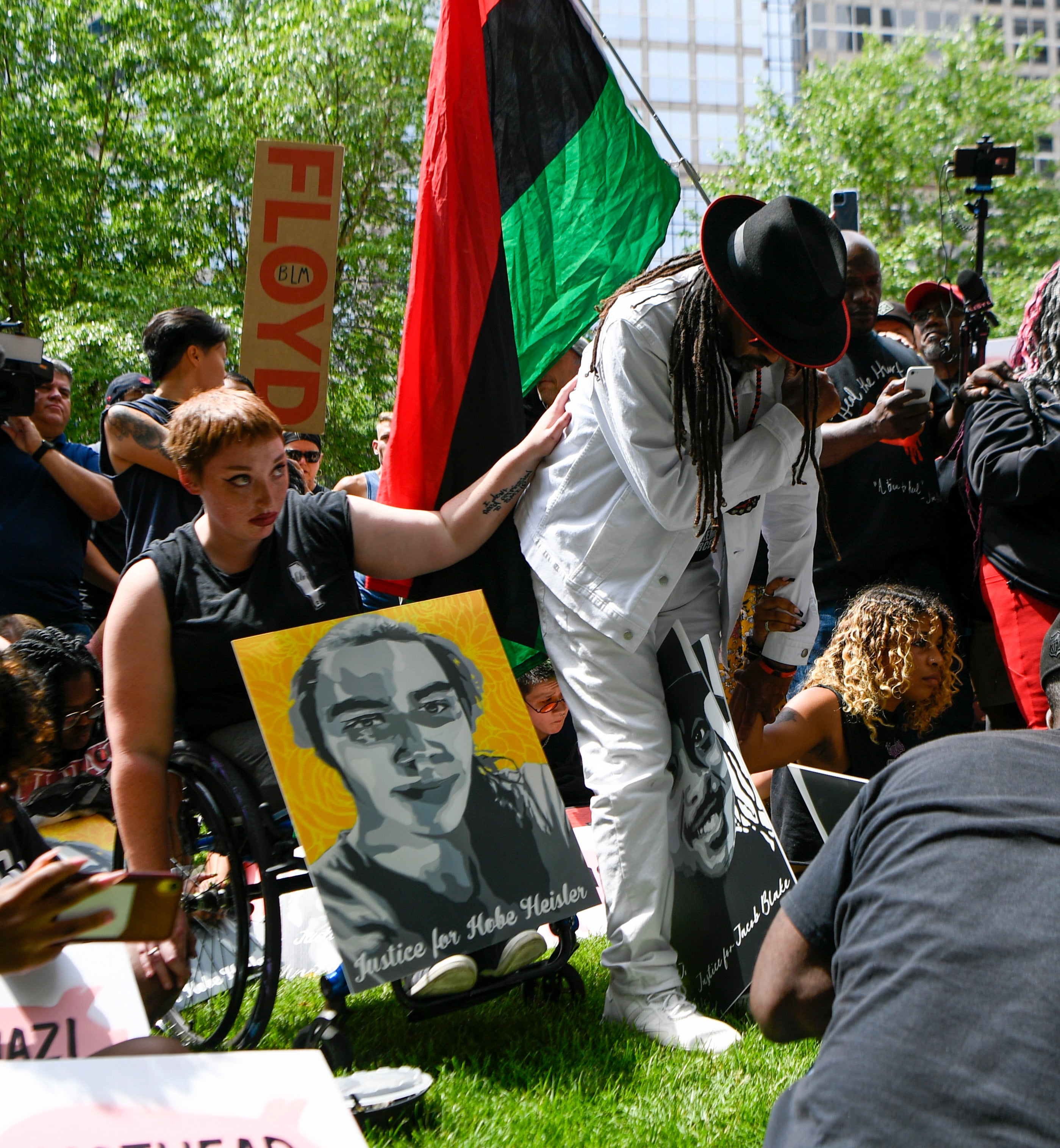 Supporters gather outside the Hennepin Government Center and listen to the live broadcast