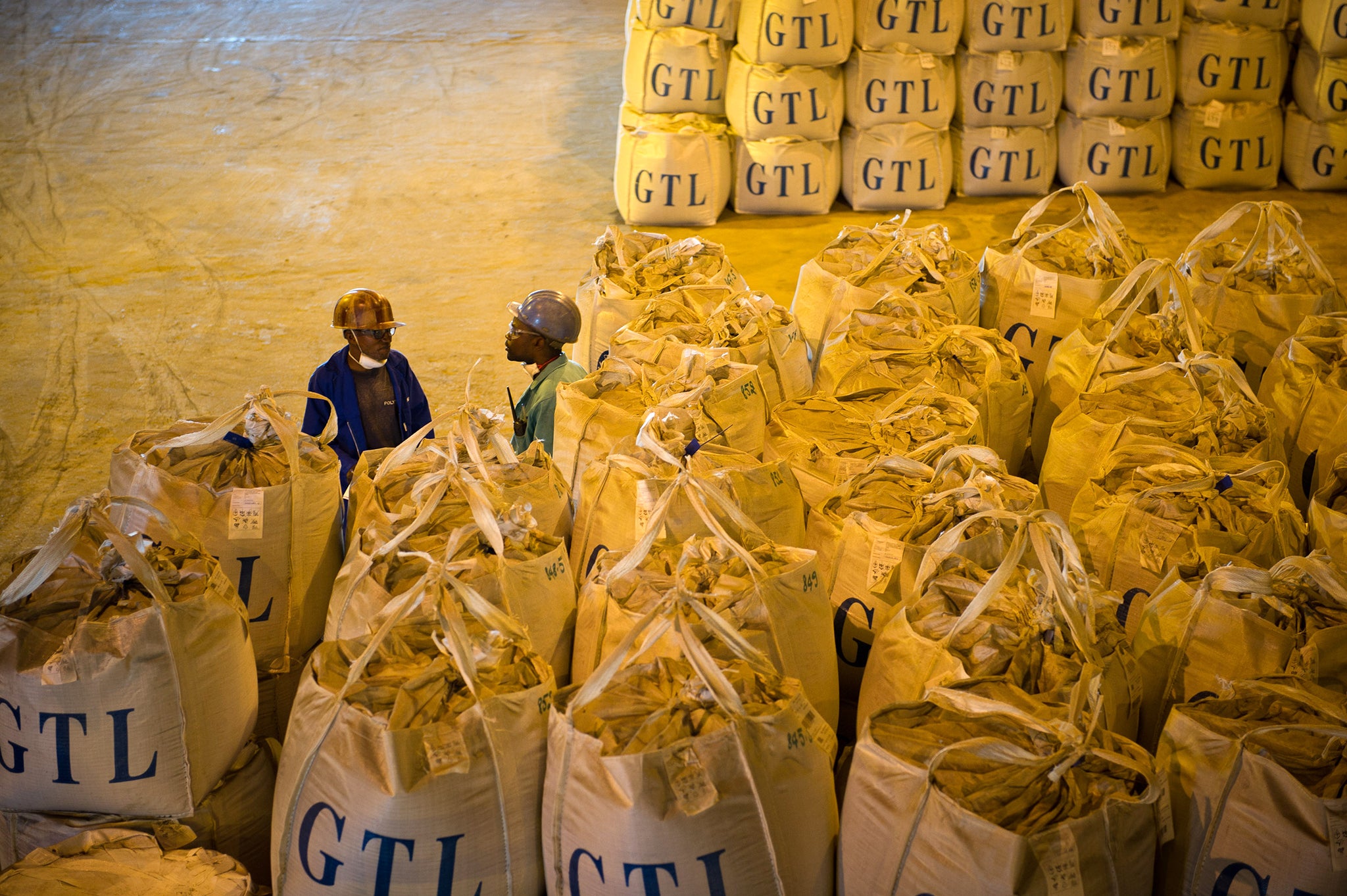 Congolese workers sort through bags of cobalt and copper, rich resources in the DRC used in electrical devices