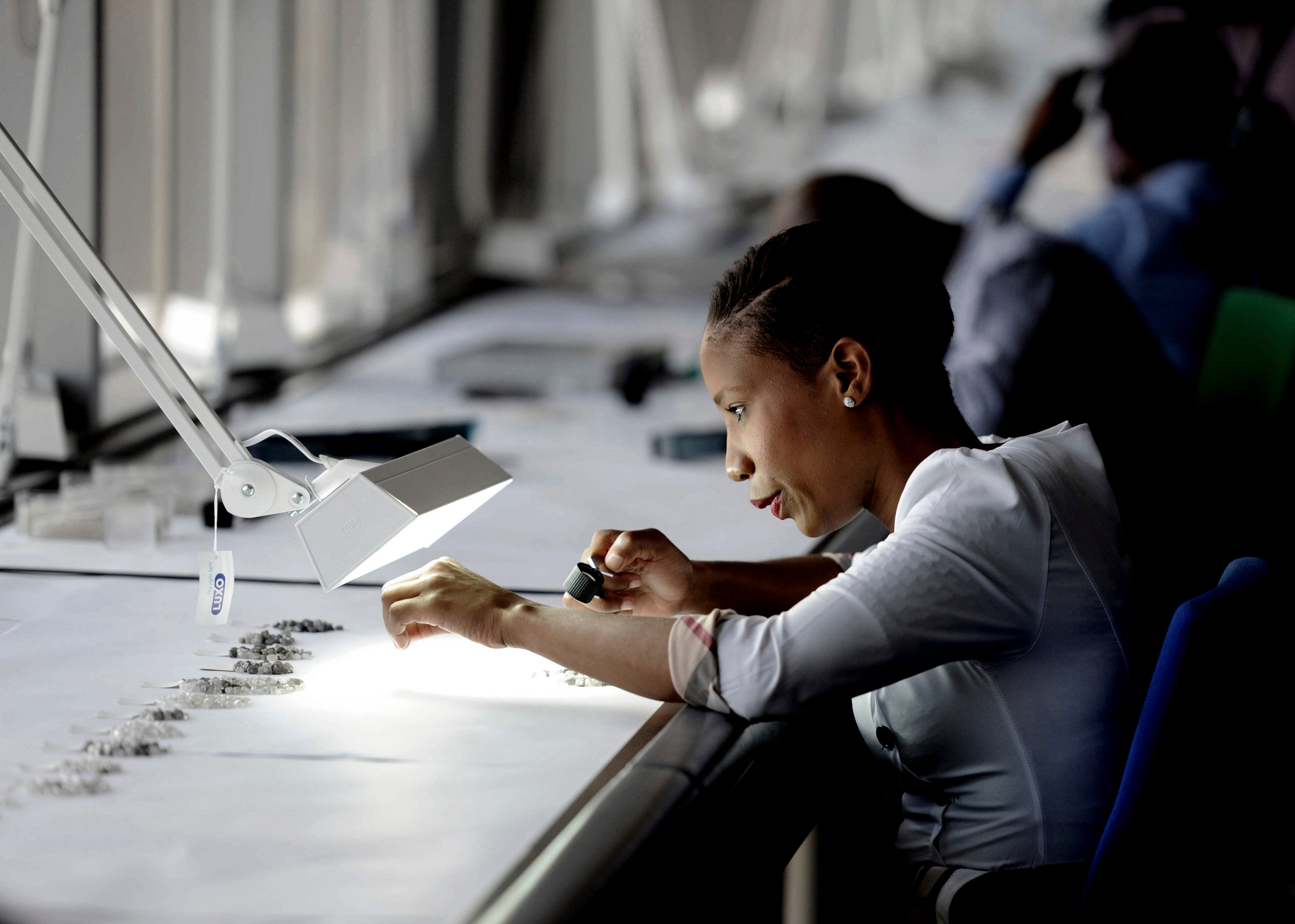 A De Beers’ clerk grades diamonds from Botswana, which managed to avoid the blood diamond violence that ravaged many other Sub-Saharan countries