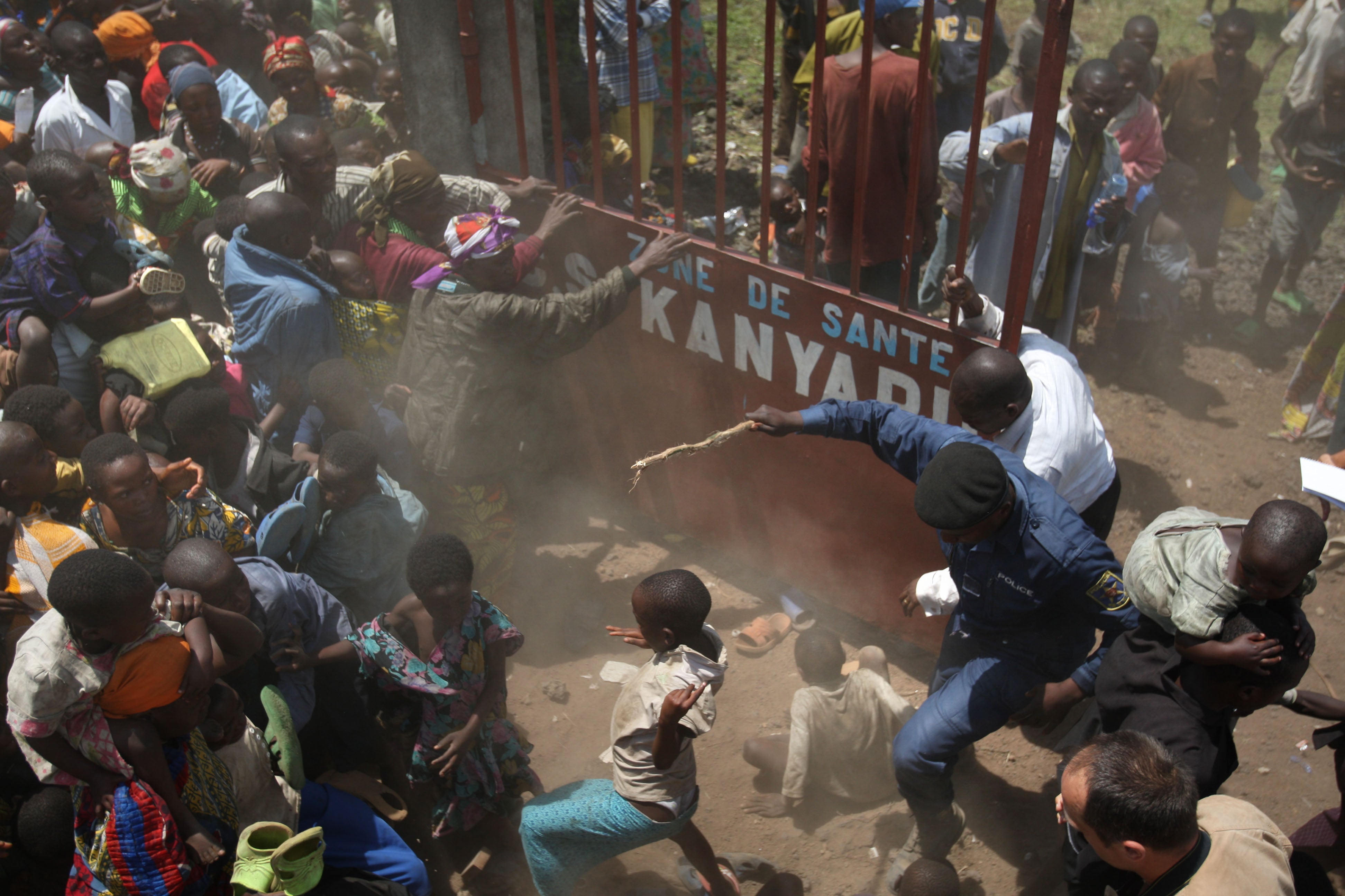 Refugees try to enter a help centre in North Kivu in the DRC after a surge of conflict forced thousands to flee their homes and camps