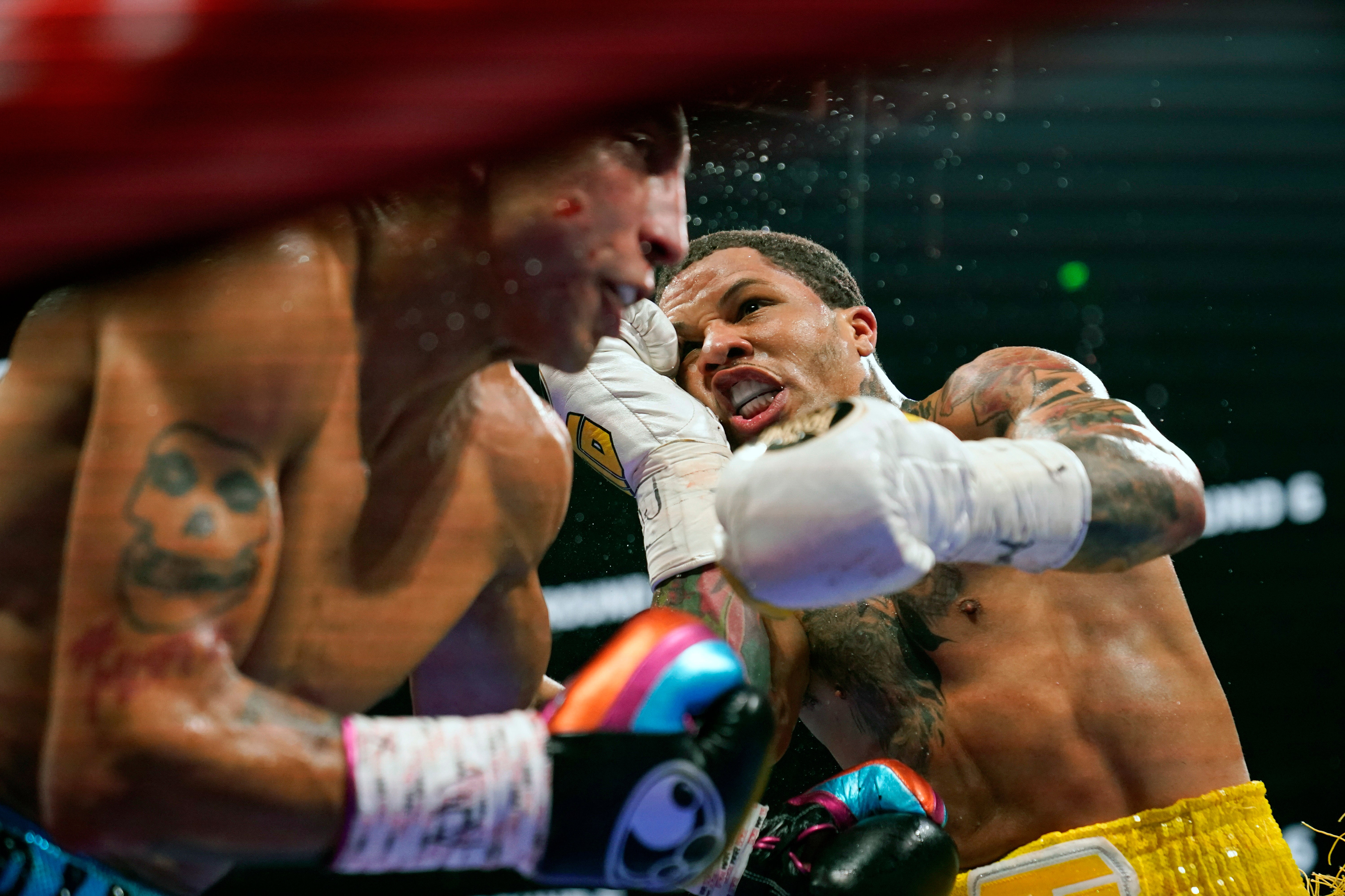 Gervonta Davis hits Mario Barrios in their WBA Super Lightweight world championship boxing match in Atlanta