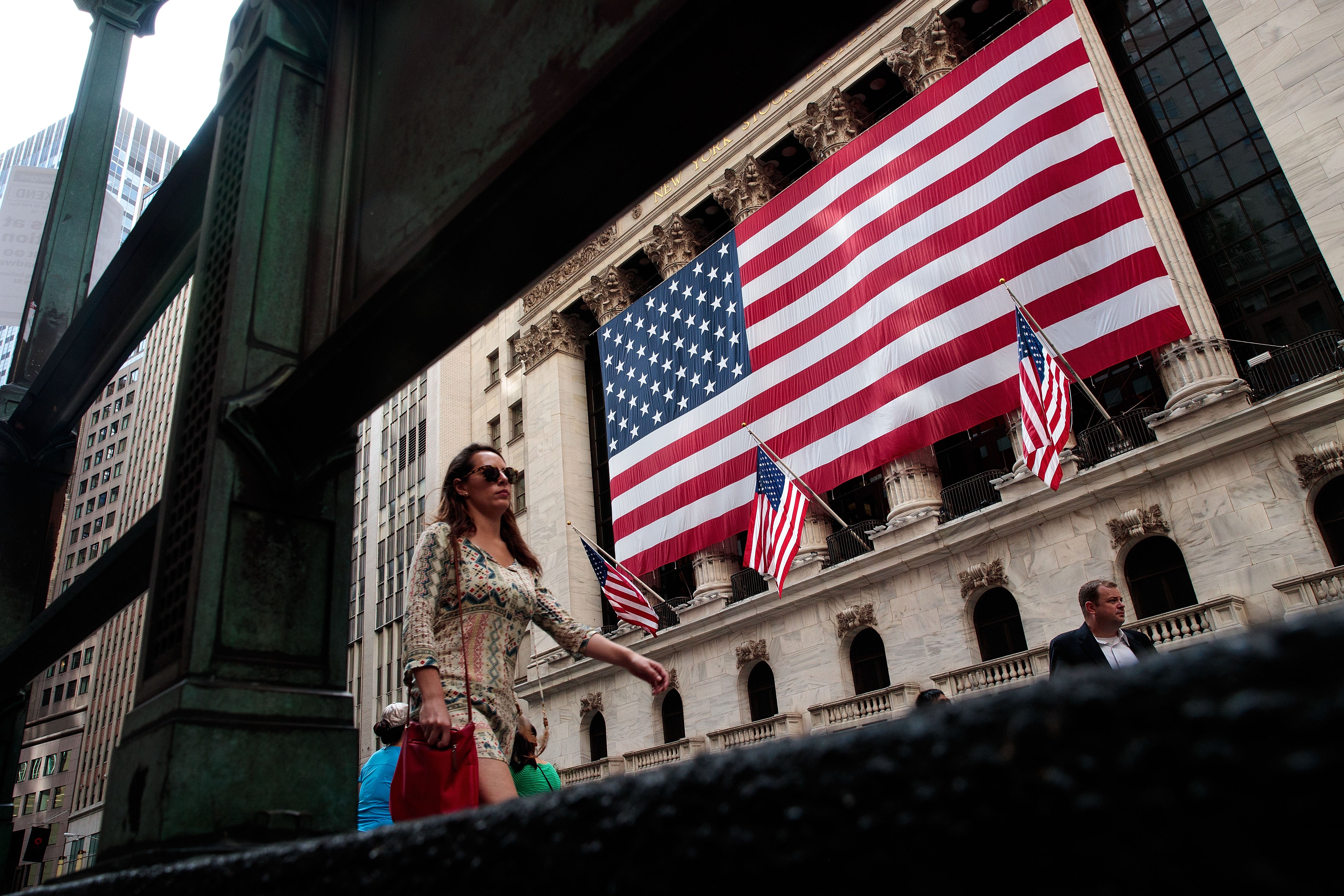 People walk past the New York Stock Exchange (NYSE), 13 September, 2016 in New York City.