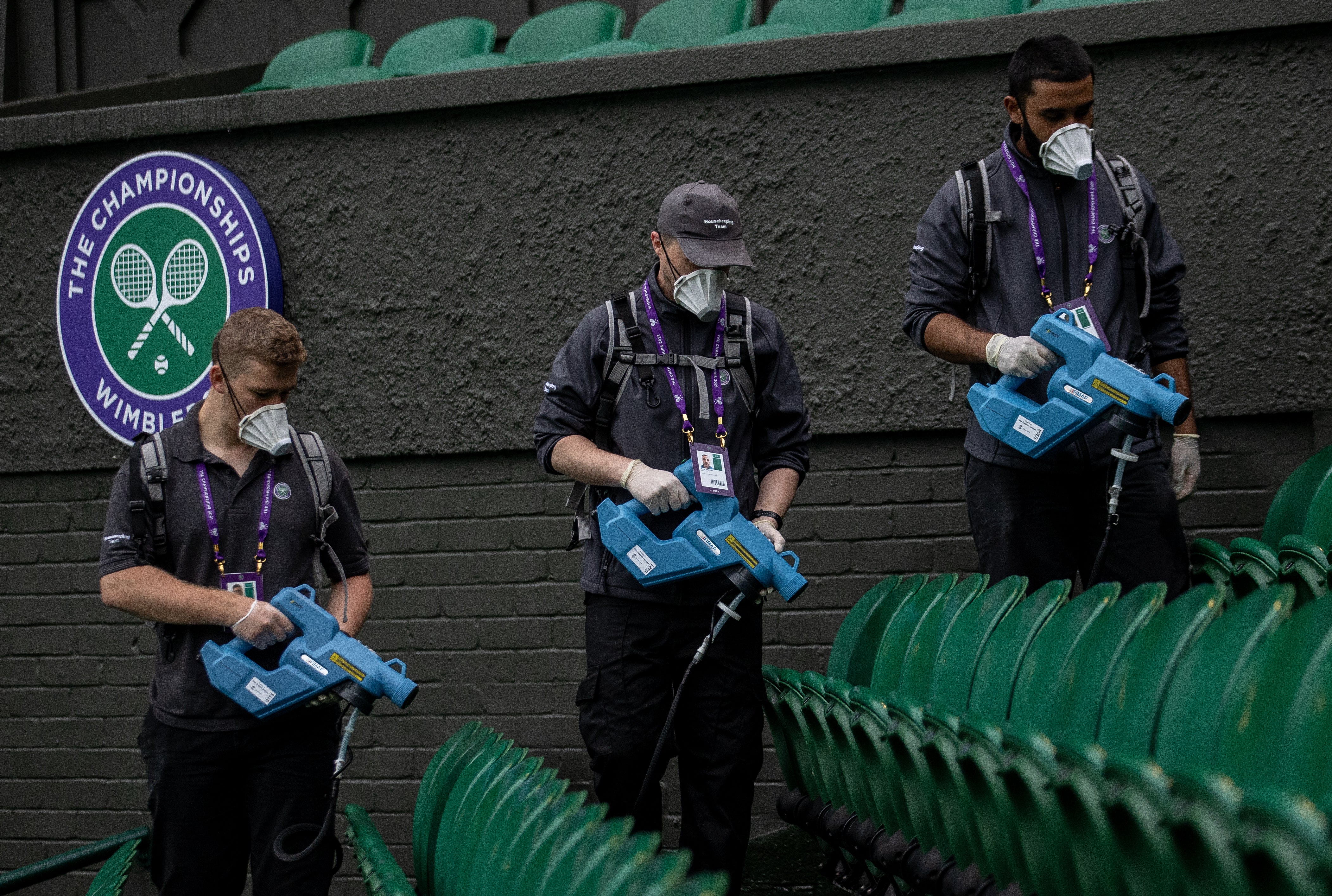 Ground staff sanitise the seats