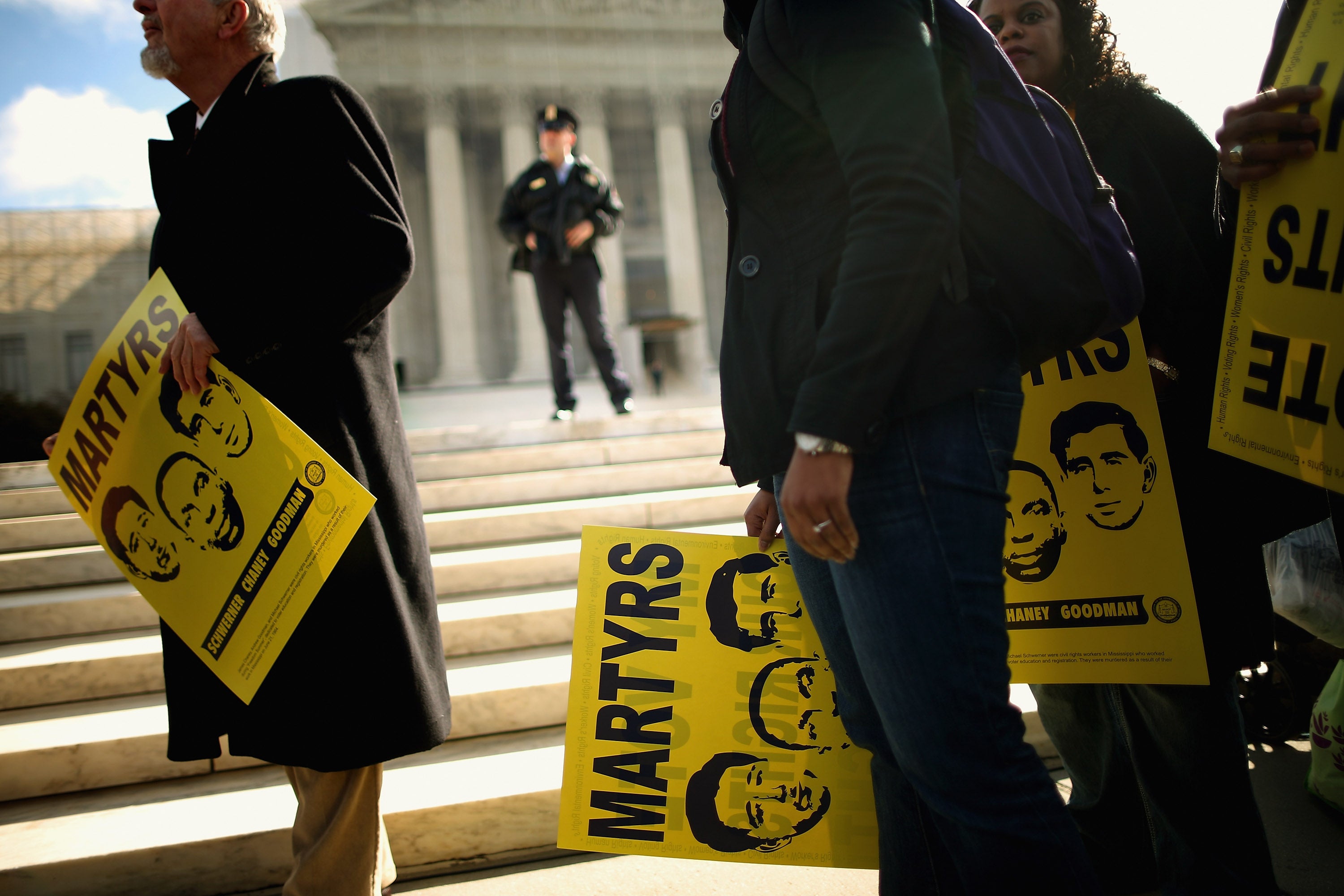 Holding signs with images of murdered Mississippi civil rights workers James Earl Chaney, Andrew Goodman, and Michael Schwerner, demonstrators rally in front of the US Supreme Court on 27 February, 2013 in Washington, DC. Previously sealed files on the 1964 killings of the three men have been released for public viewing.