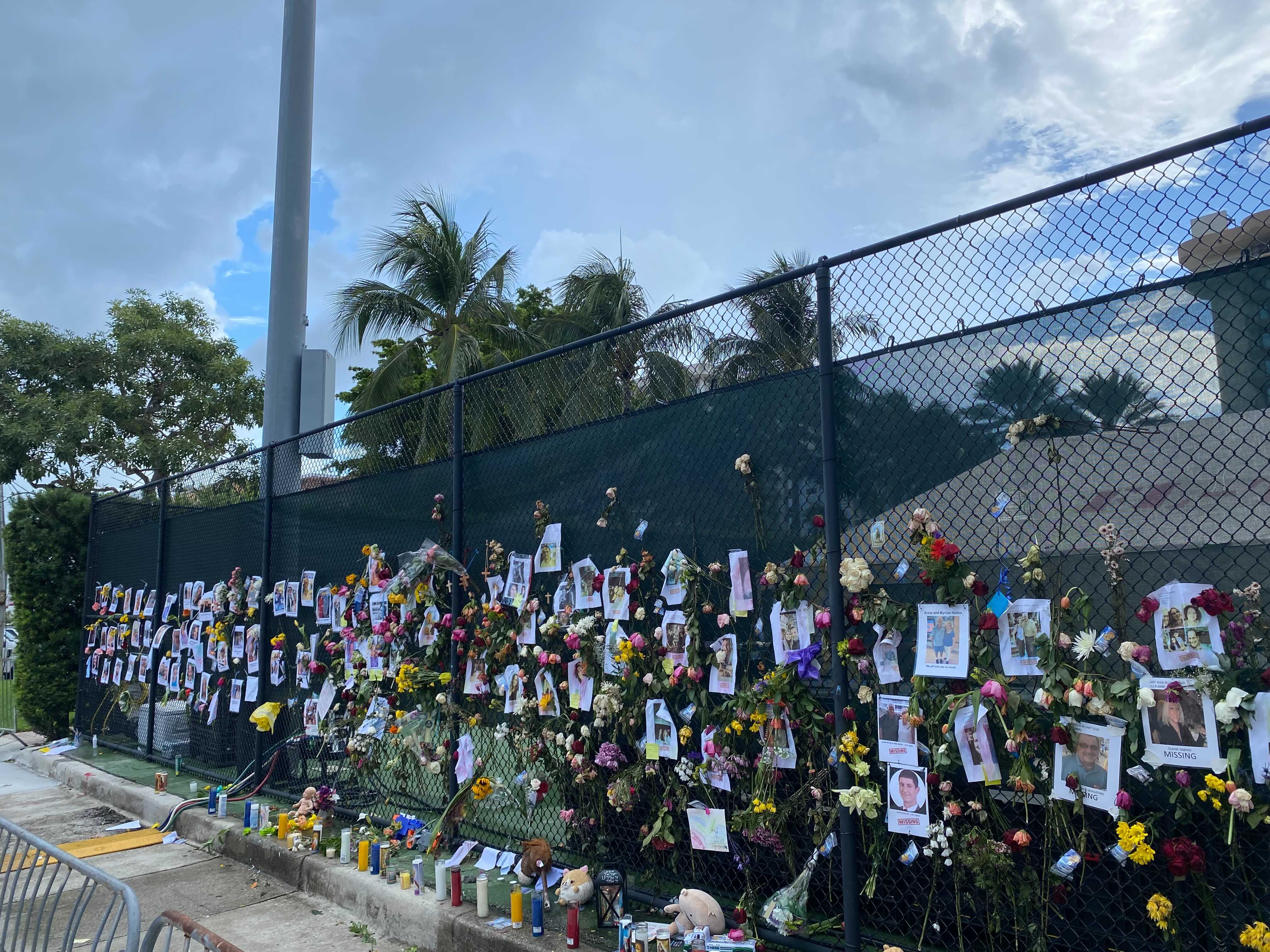 Tributes to victims and missing people line a street in Surfside, Florida.