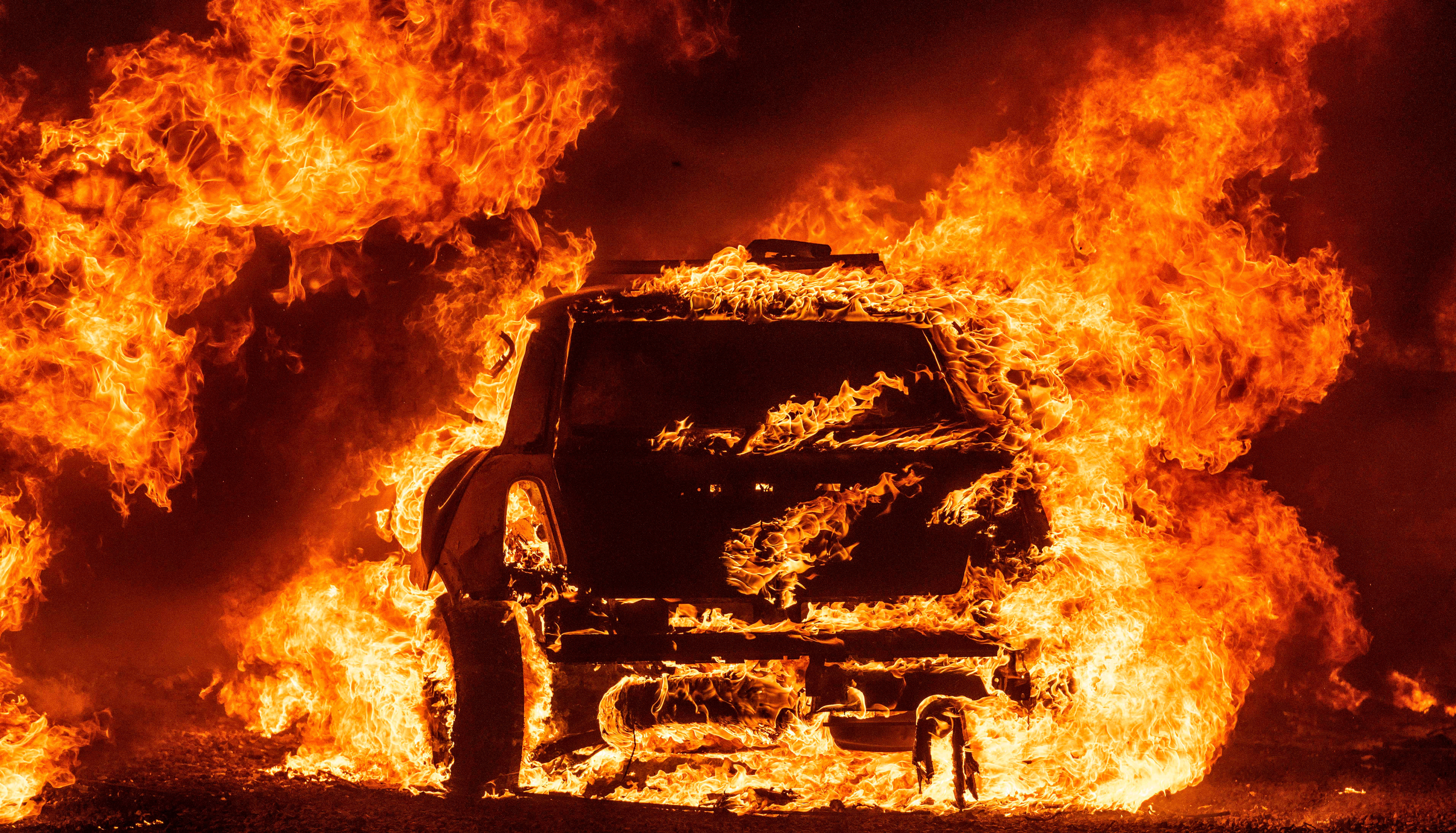 A car burning outside Vacaville, California, during the Lightning Complex fire