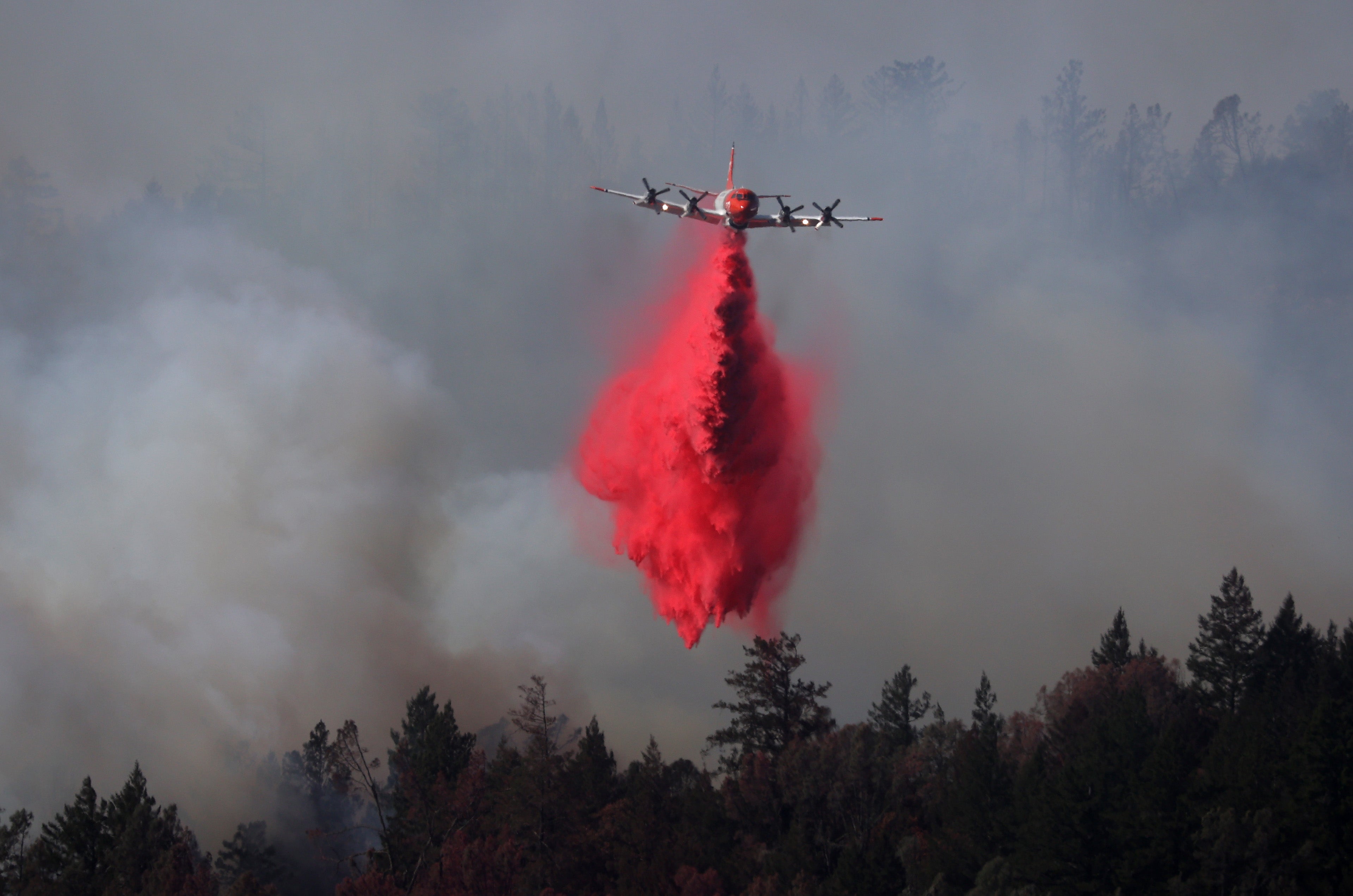 A plane drops fire retardant on the Glass Fire last September