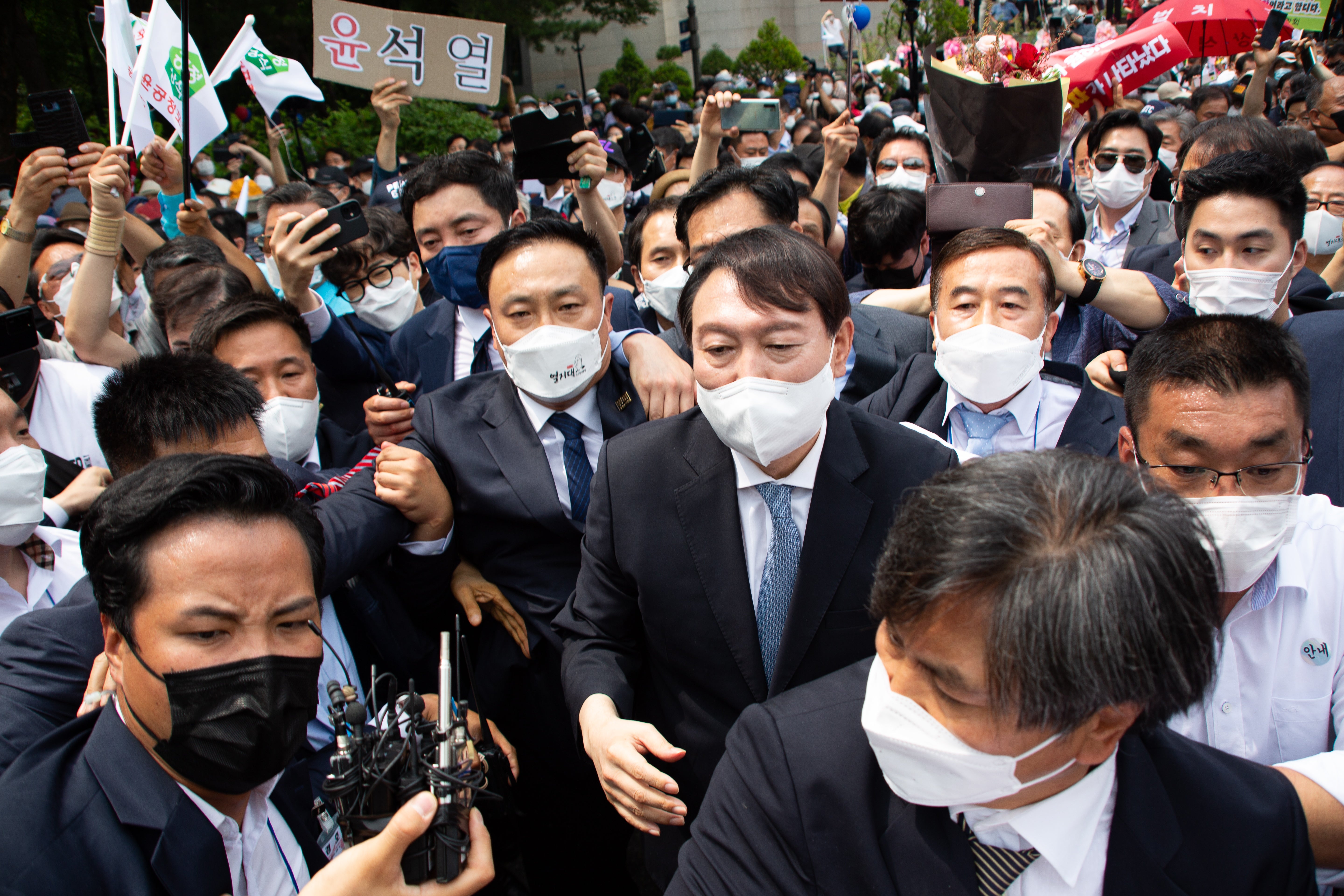 Yoon Suk-yeol (C) leaves after the press conference