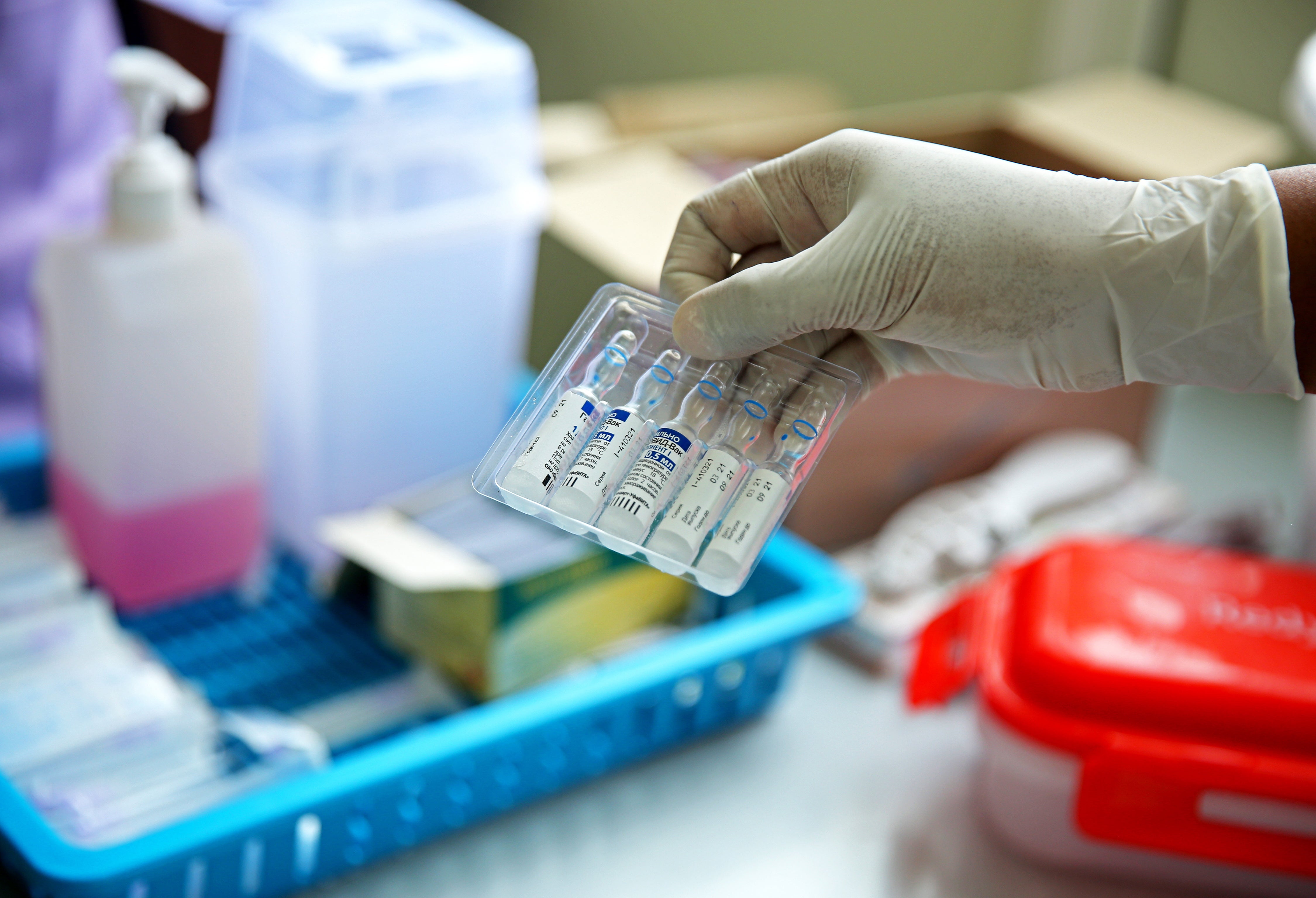 A health official holds the Russian Sputnik V vaccine, which is said to still be 90% effective against the variant first discovered in India