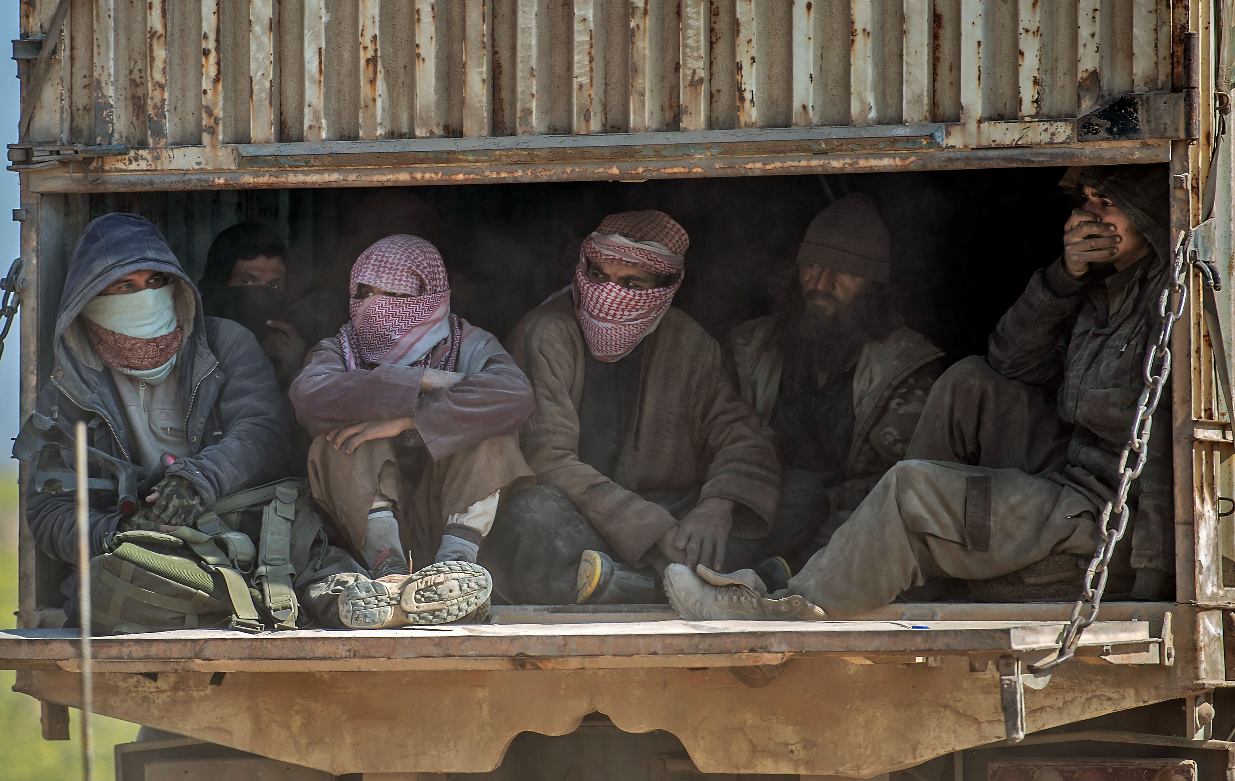 Men identified as Islamic State group fighters who surrendered to Kurdish-led Syrian Democratic Forces (SDF) in February 2019