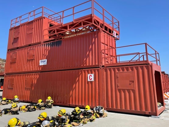 Firefighters training in San Diego use shipping containers to mimic burning buildings