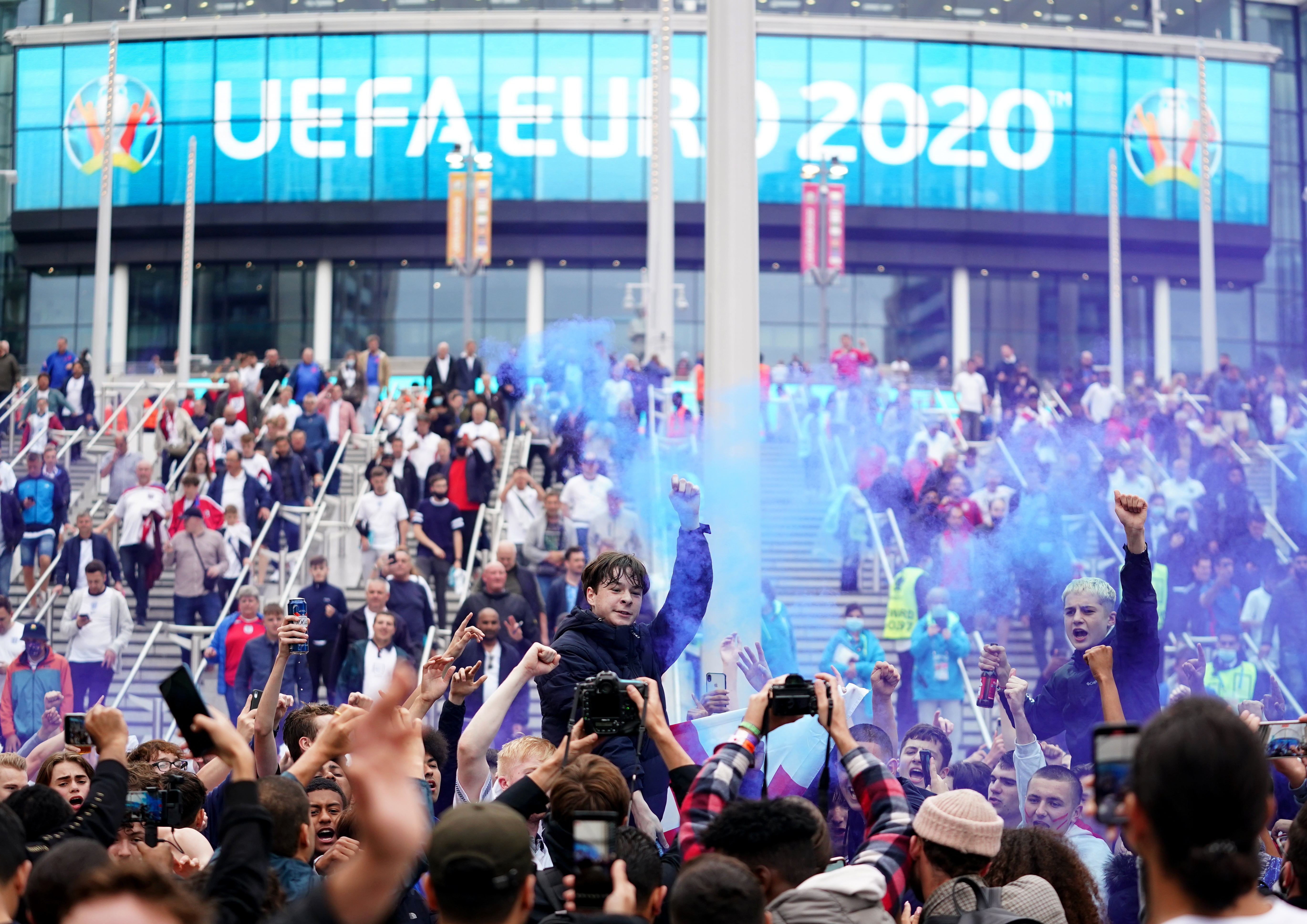 England supporters celebrate victory over Germany in the fans' zone outside Wembley Stadium