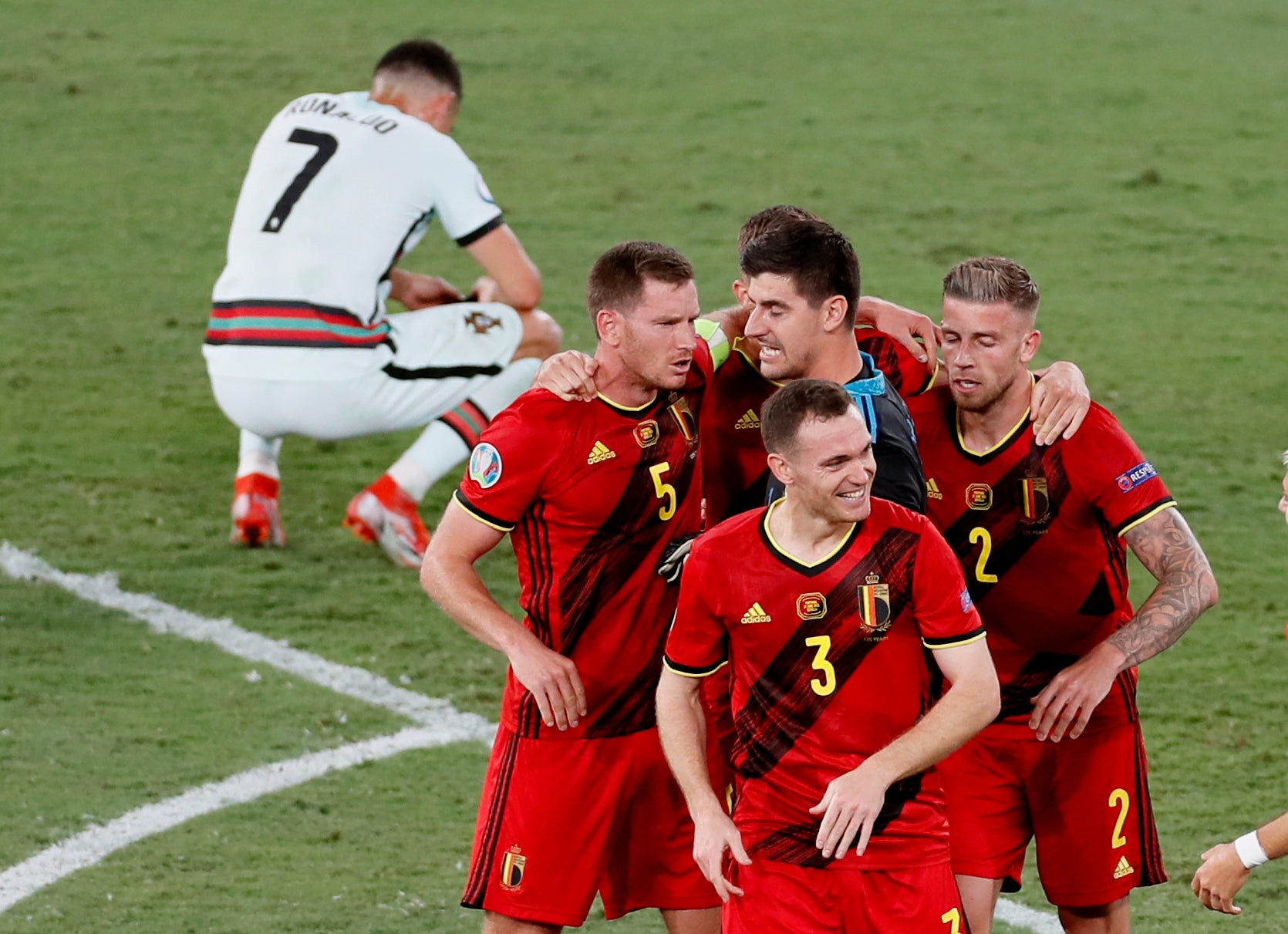 Belgium players celebrate winning 1-0 as Portugal’s Cristiano Ronaldo reacts after the Euro 2020 game in Seville