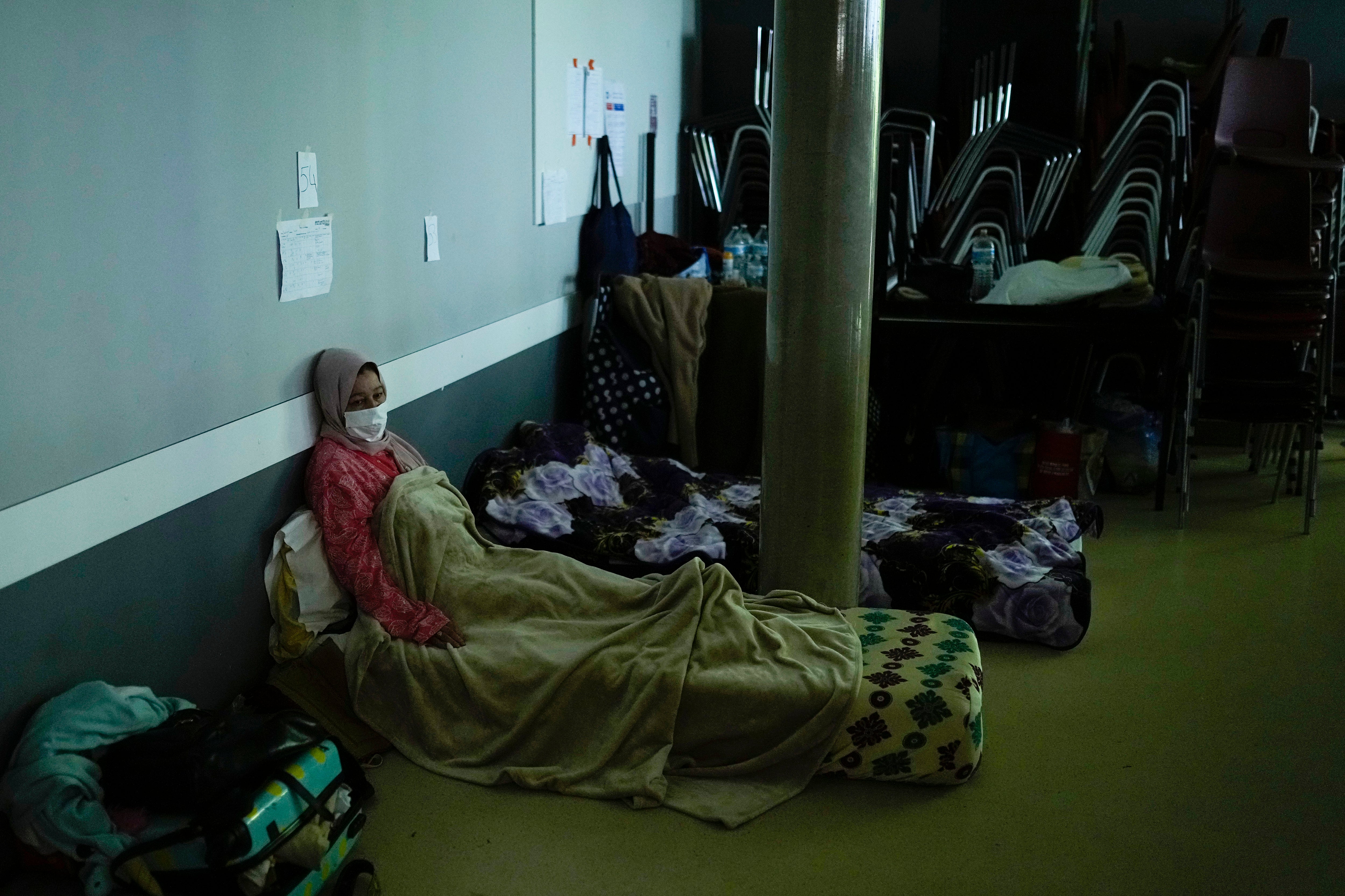 A woman on hunger strike rests as she occupies with others a space of the VUB Dutch-speaking university in Brussels