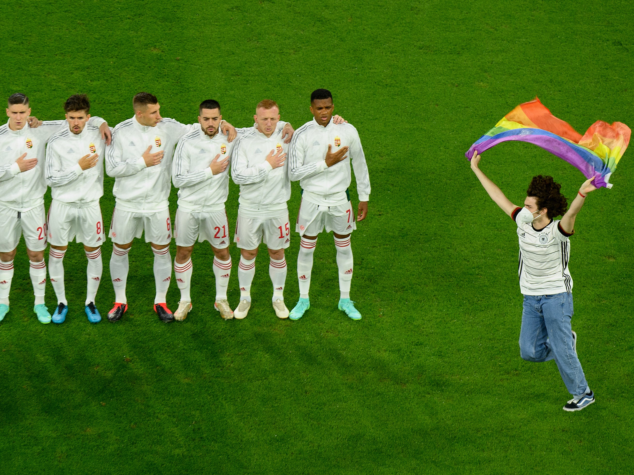 A pitch invader with a rainbow flag prior to the match between Germany and Hungary