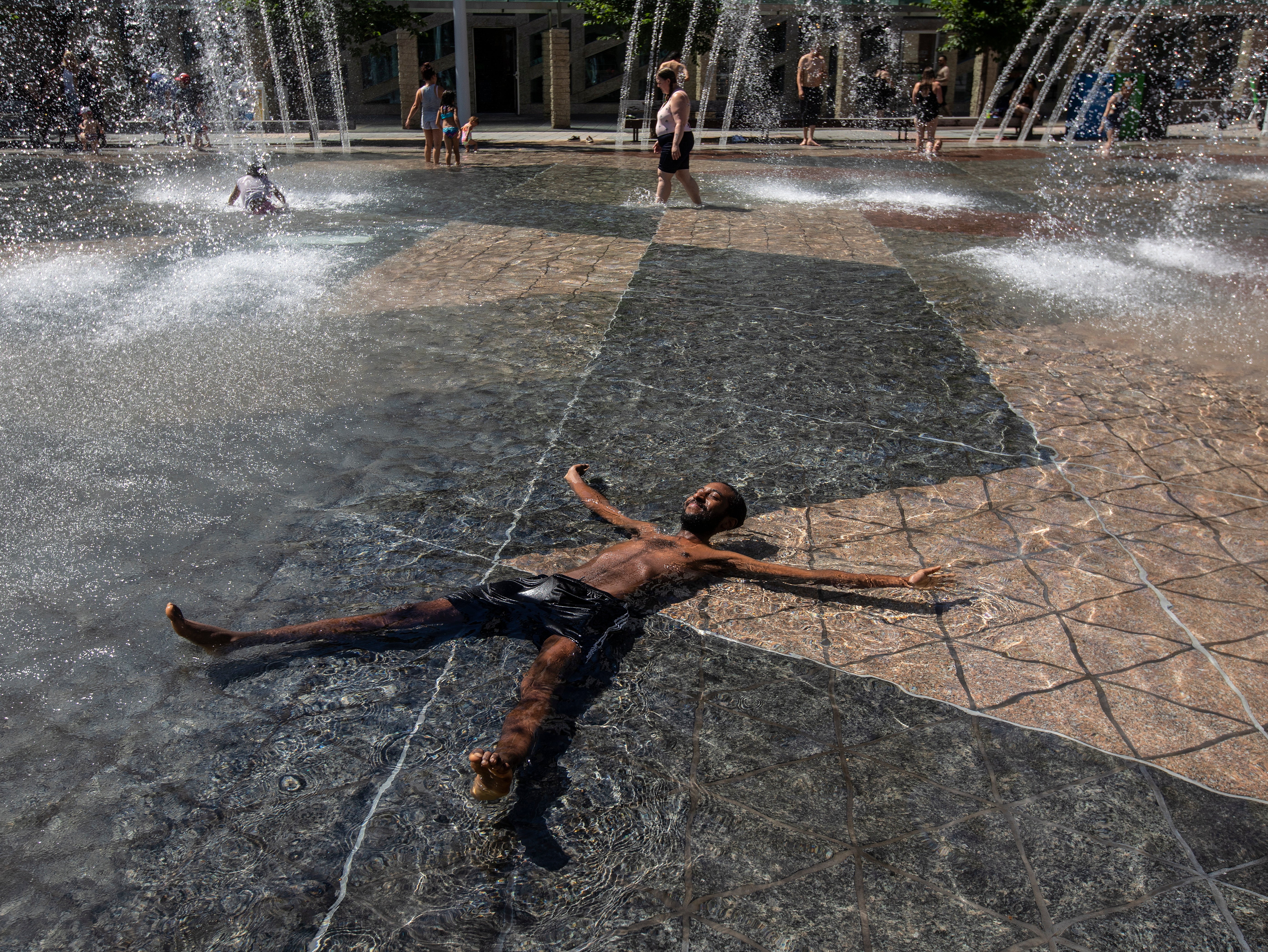 A man cools off in a city hall pool in Alberta, Canada